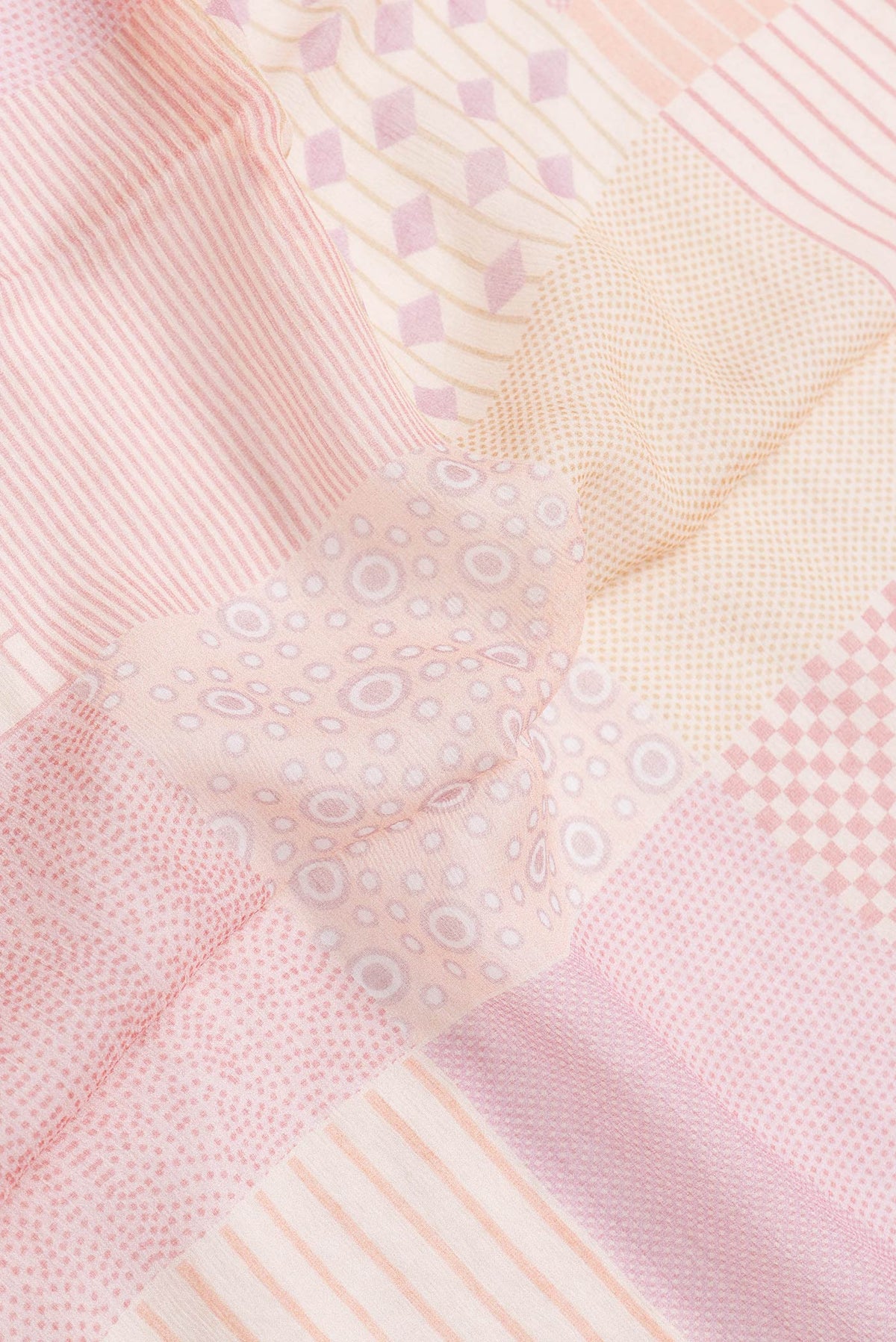 Close up of Golden Peach Dual Tone Mysore Chiffon Saree with Printed design on the body and Thread Border.  displaying folds