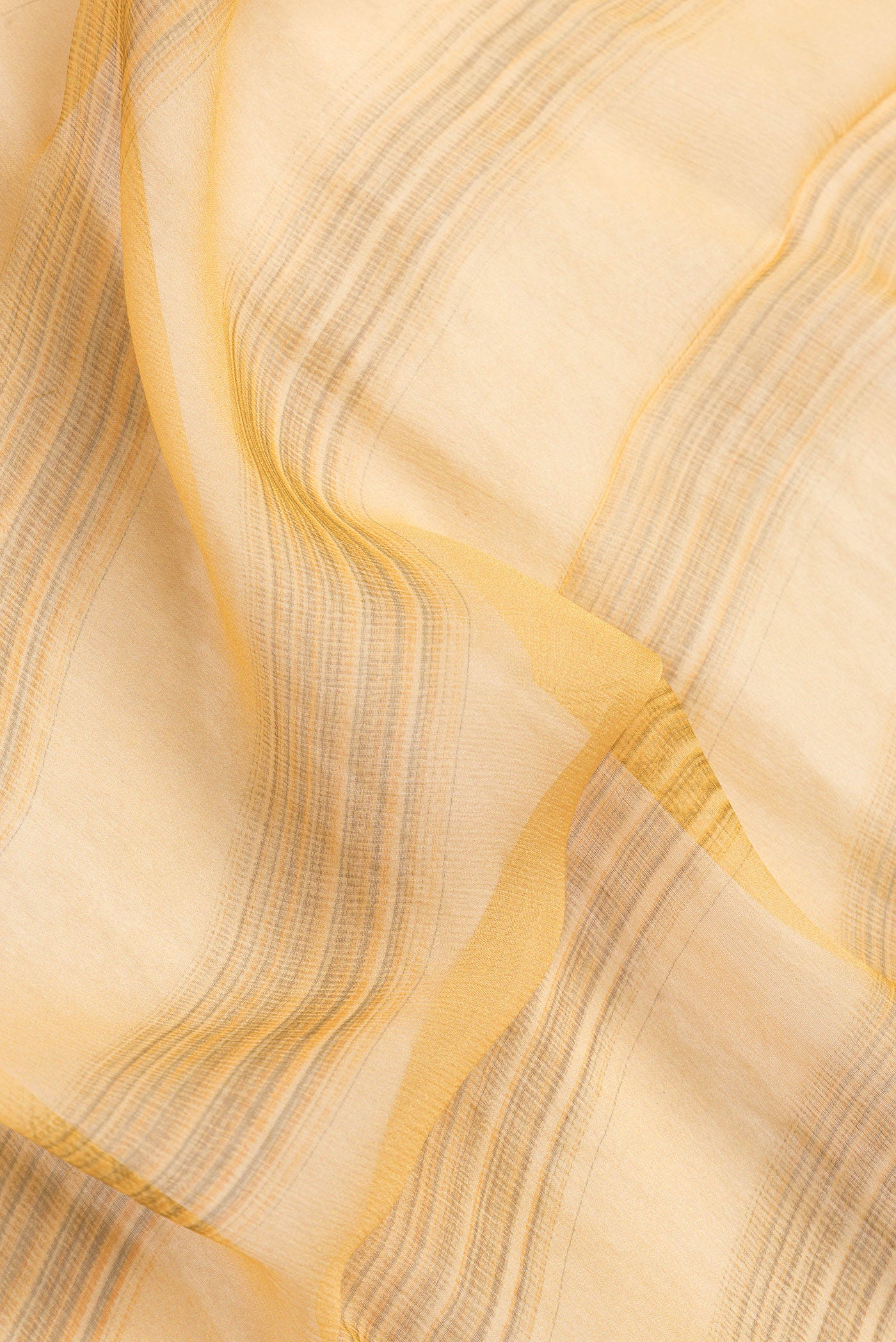 Close up of Sandal Dual Tone Mysore Chiffon Saree with Printed design on the body and Thread Border.  displaying folds
