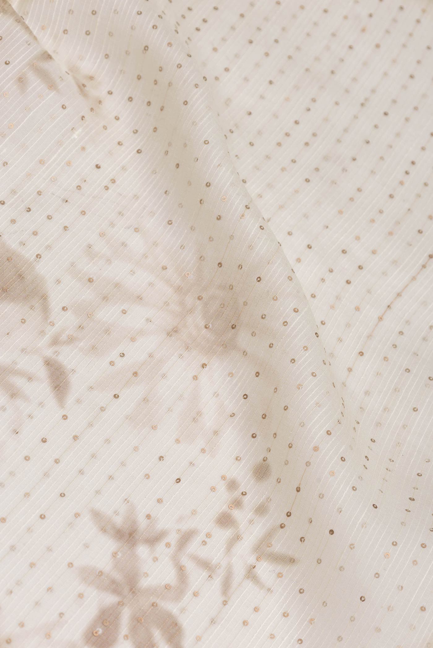 Close up of Beige Dual Tone Tussar Saree with Embroidery on the body and Without Border displaying folds