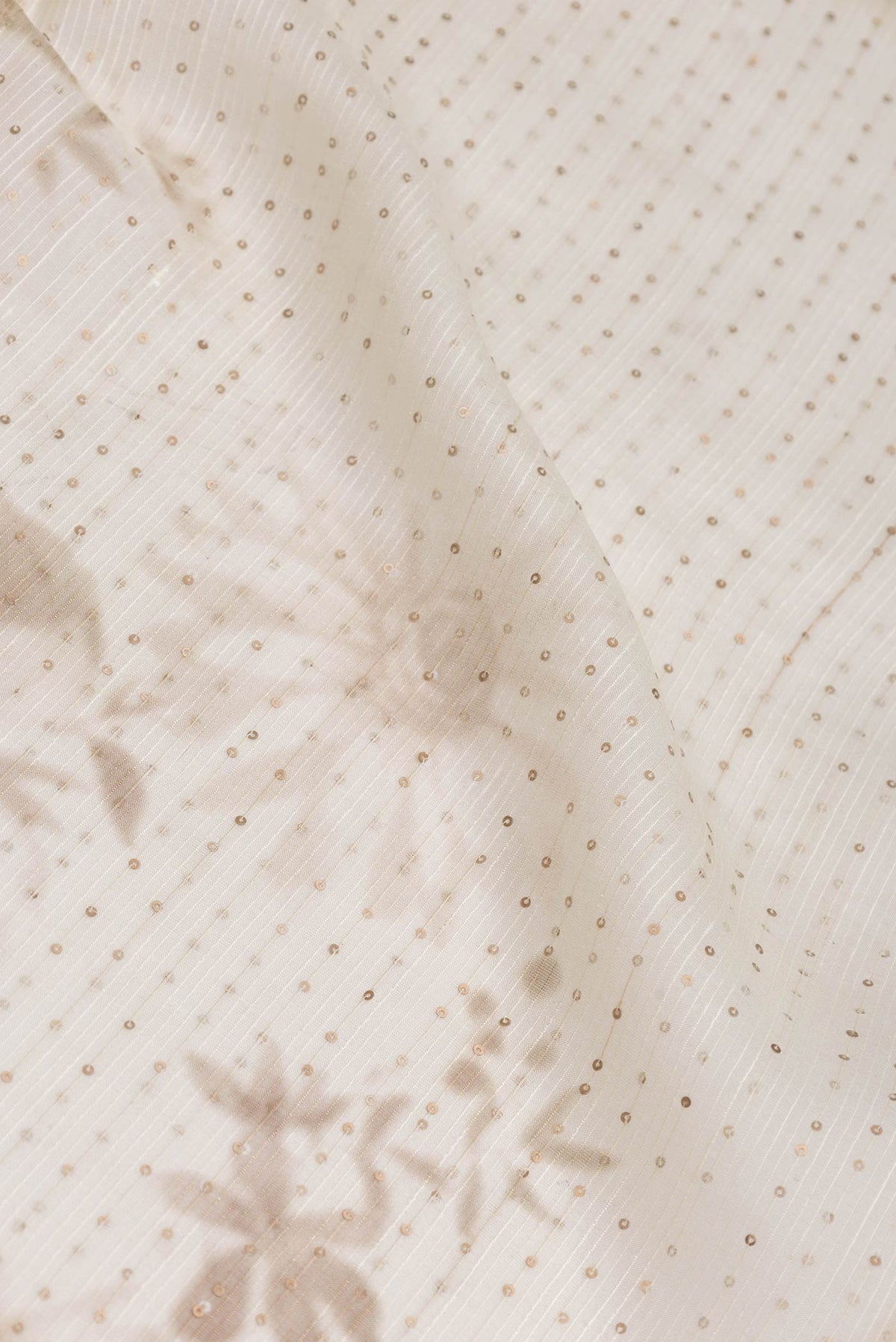 Close up of Beige Dual Tone Tussar Saree with Embroidery on the body and Without Border displaying folds