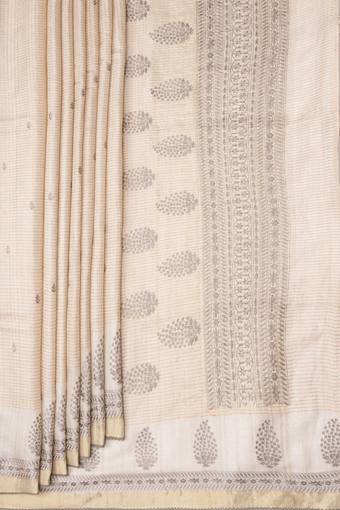 Pleats and pallu of Beige Dual Tone Tussar Silk Saree with Checked design on the body and Embroidery Border. 