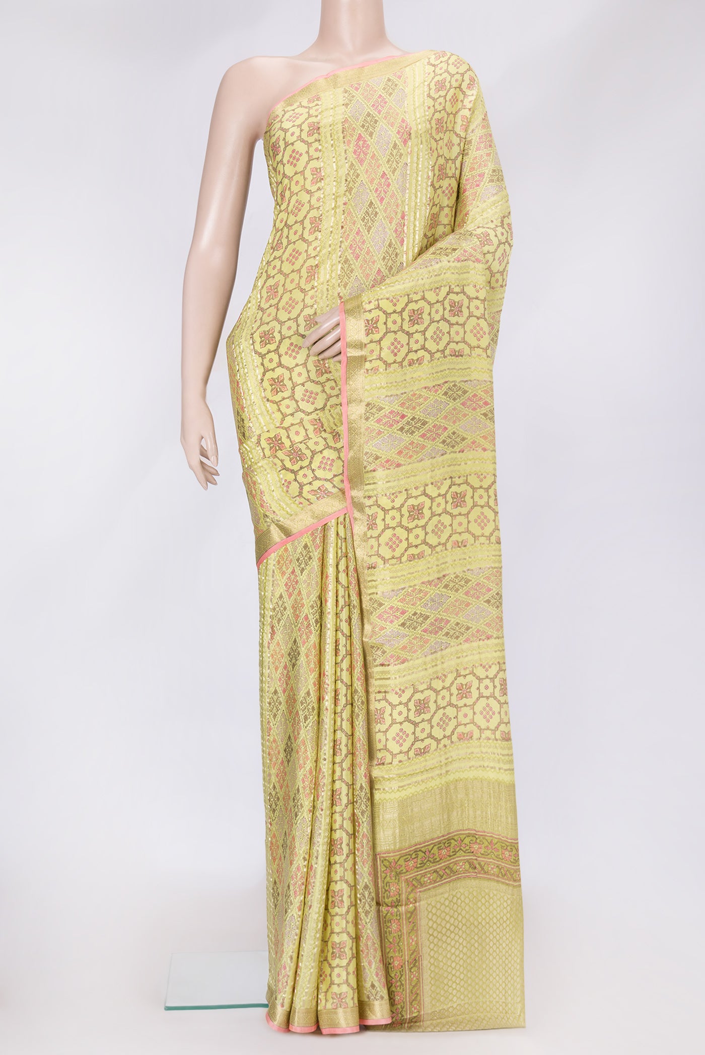 Lemon Yellow Dual Tone Mysore Crepe Saree with Printed design on the body and Zari Border.  displayed on a mannequin