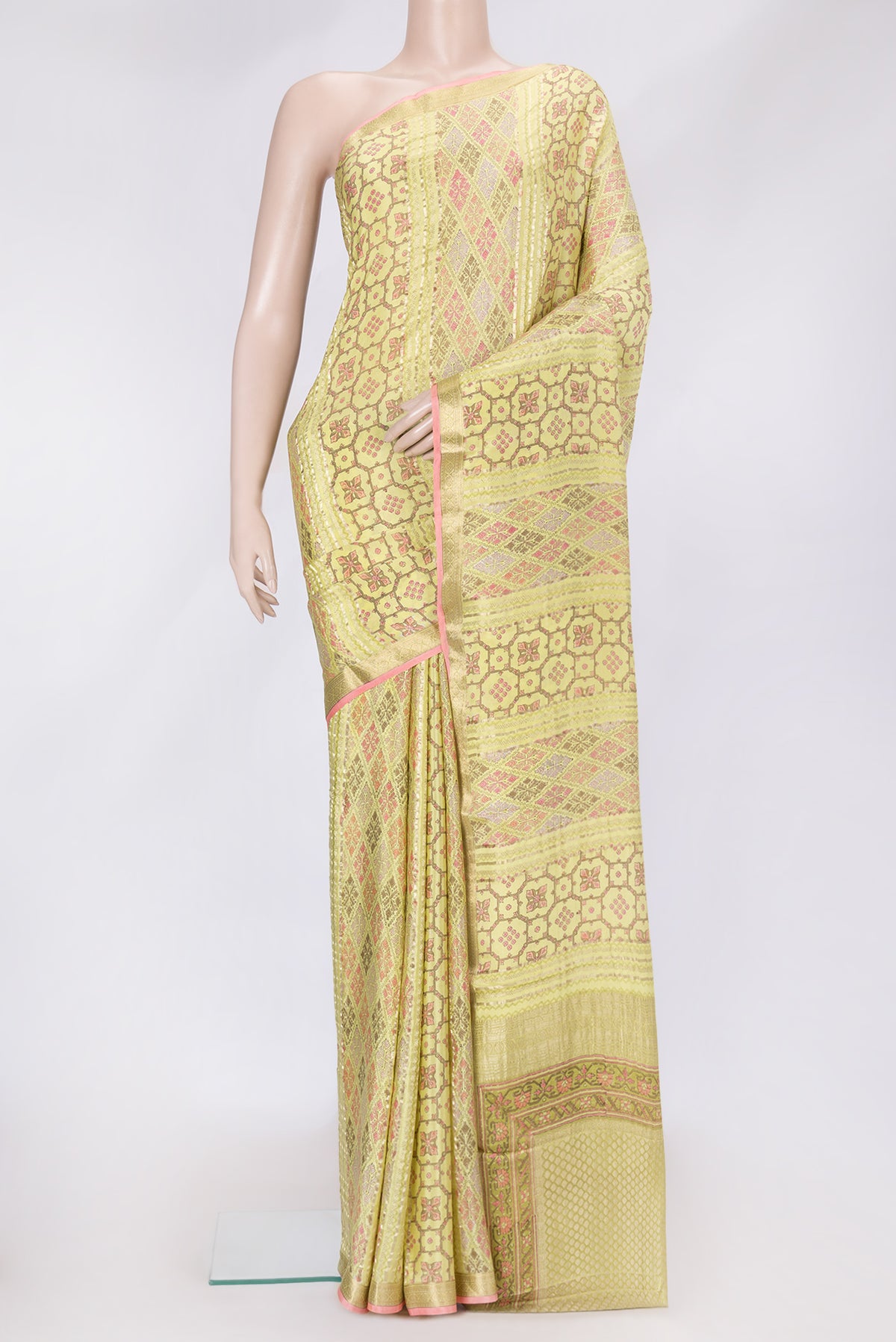 Lemon Yellow Dual Tone Mysore Crepe Saree with Printed design on the body and Zari Border.  displayed on a mannequin