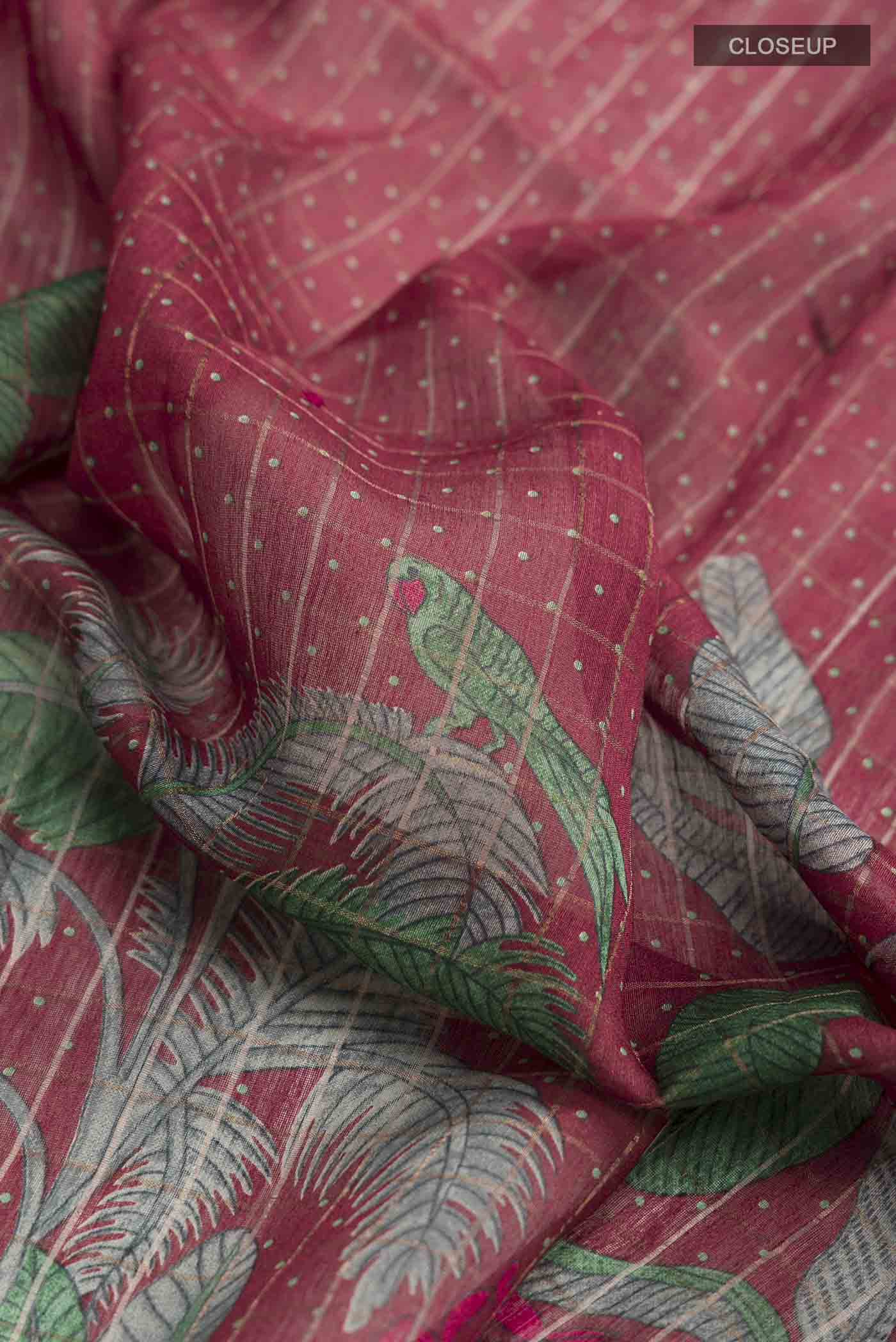 Close up of Maroon Bhagalpuri Tussar Silk Saree with Printed design on the body and Embroidery Border displaying folds
