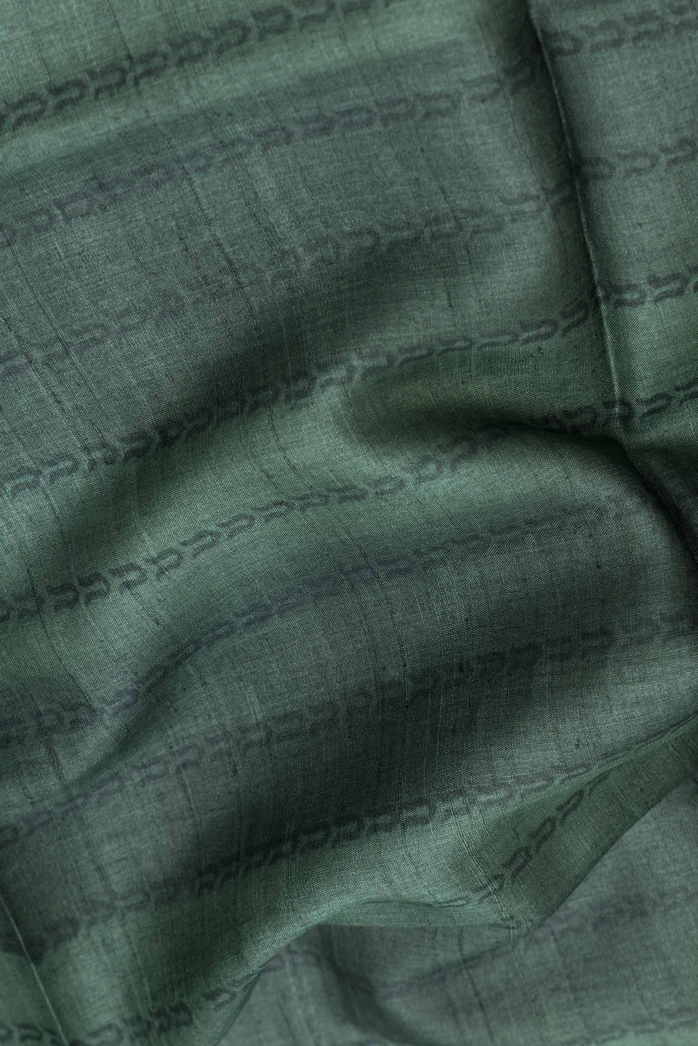 Close up of Green Dual Tone Tussar Silk SareePrinted design on the body and Plain Border displaying folds