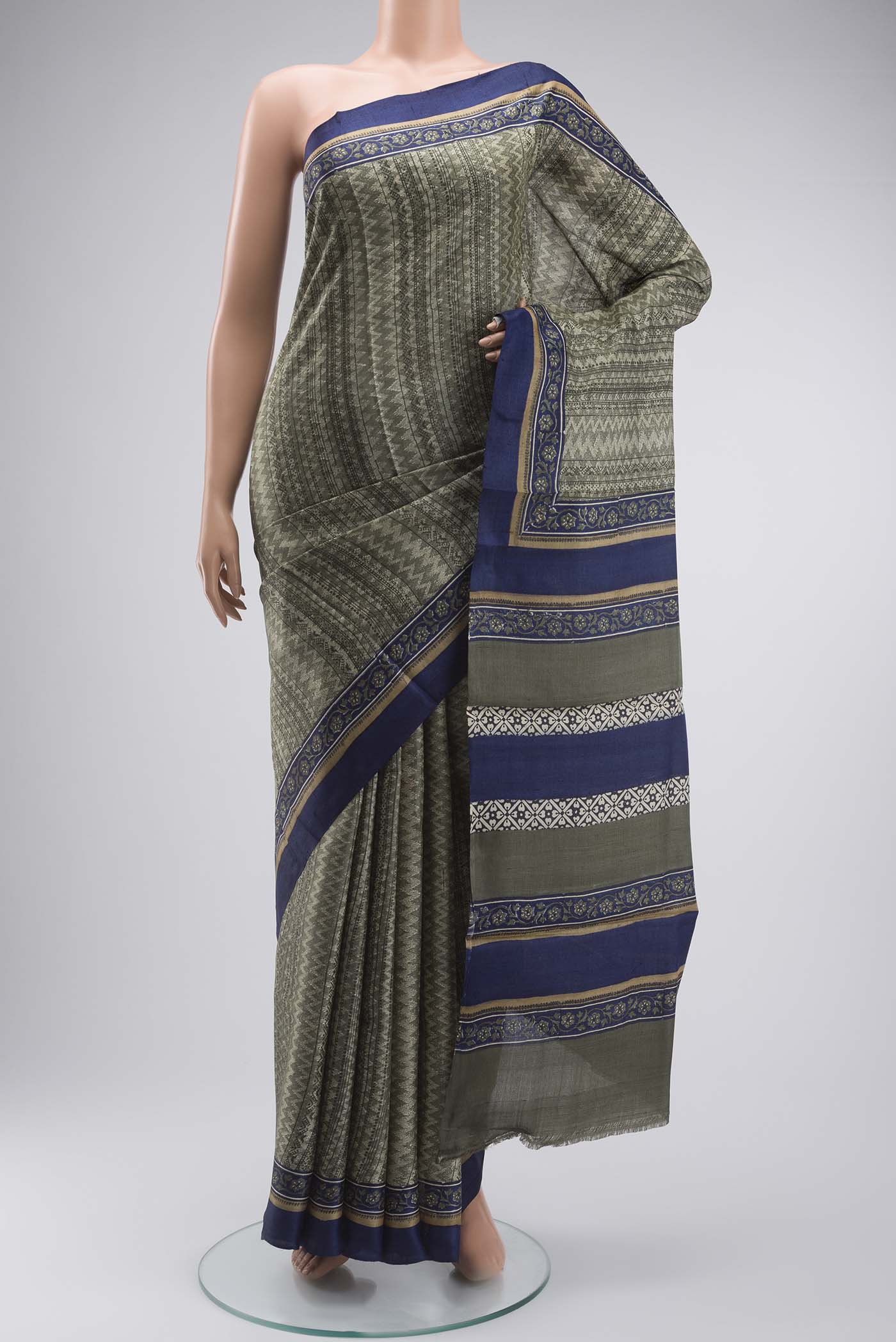 Green Tussar Silk Saree with Printed design on the body and Plain Border displayed on a mannequin