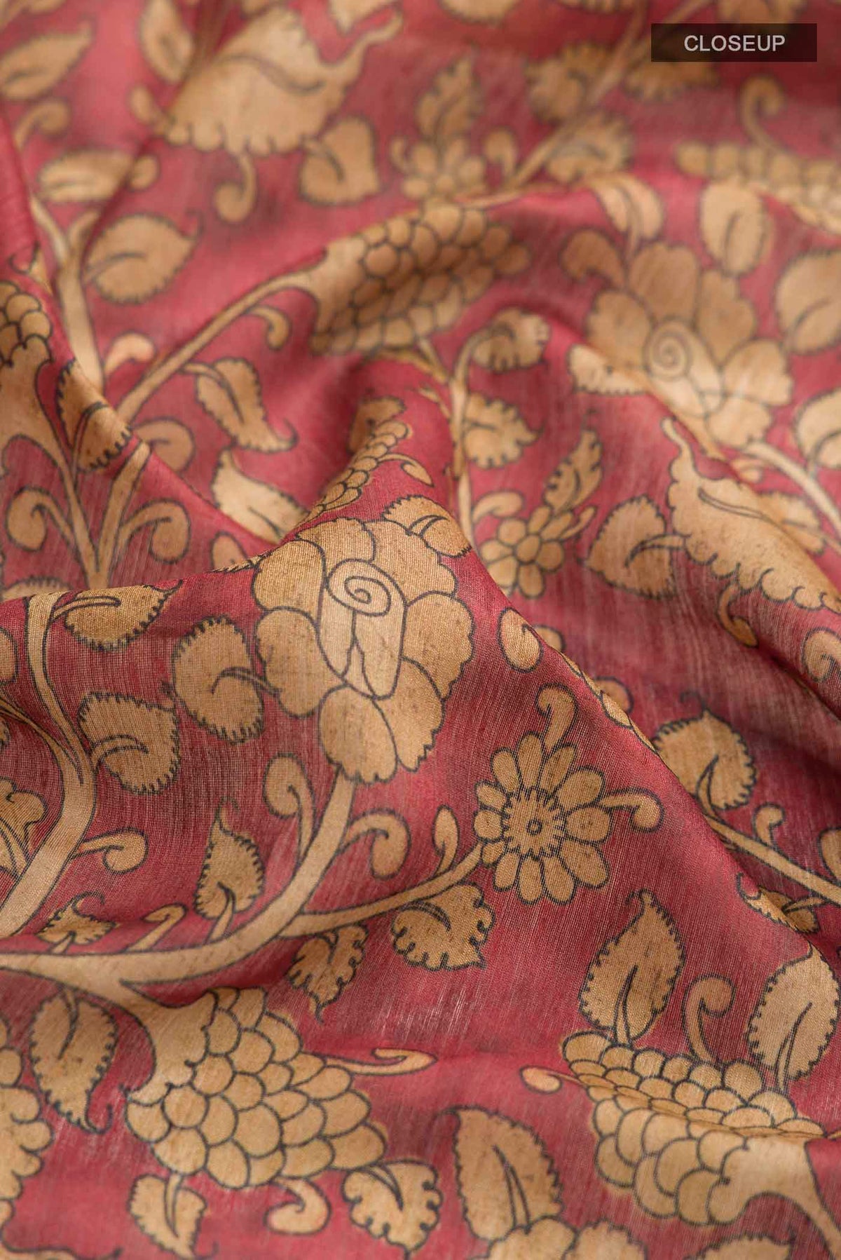 Close up of Maroon Bhagalpuri Tussar Silk Saree with Printed design on the body and Zari Border displaying folds
