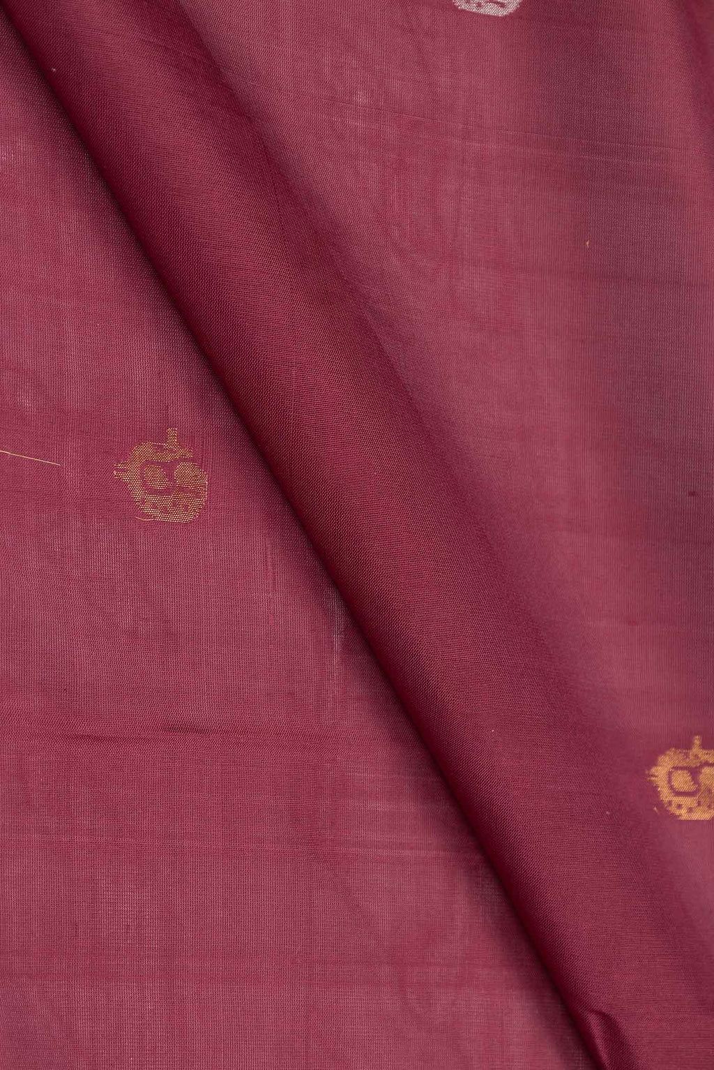 Close up of Maroon Dual Tone Uppada Silk Saree with Zari And Thread Butta on the body and Zari Border displaying folds