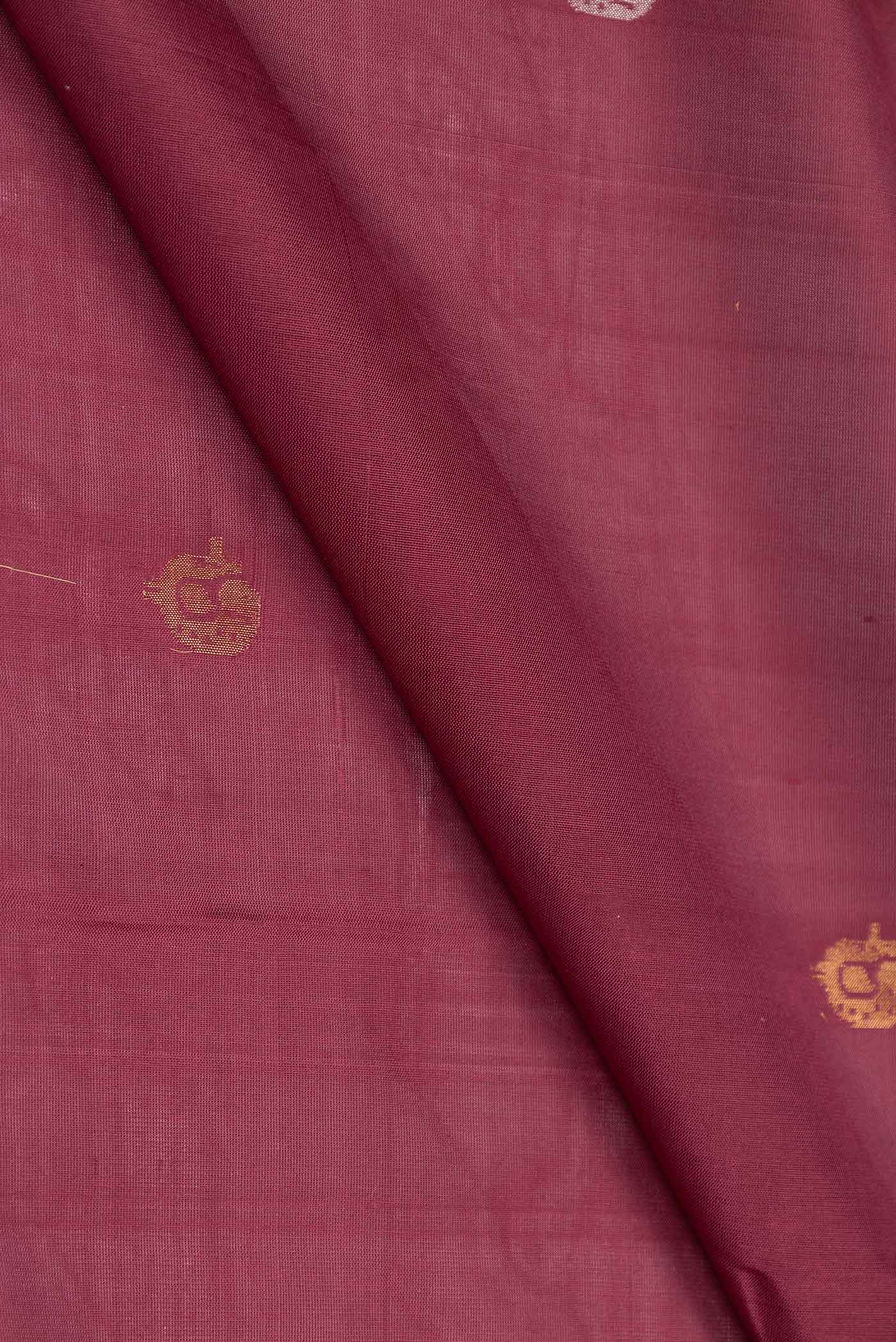 Close up of Maroon Dual Tone Uppada Silk Saree with Zari And Thread Butta on the body and Zari Border displaying folds