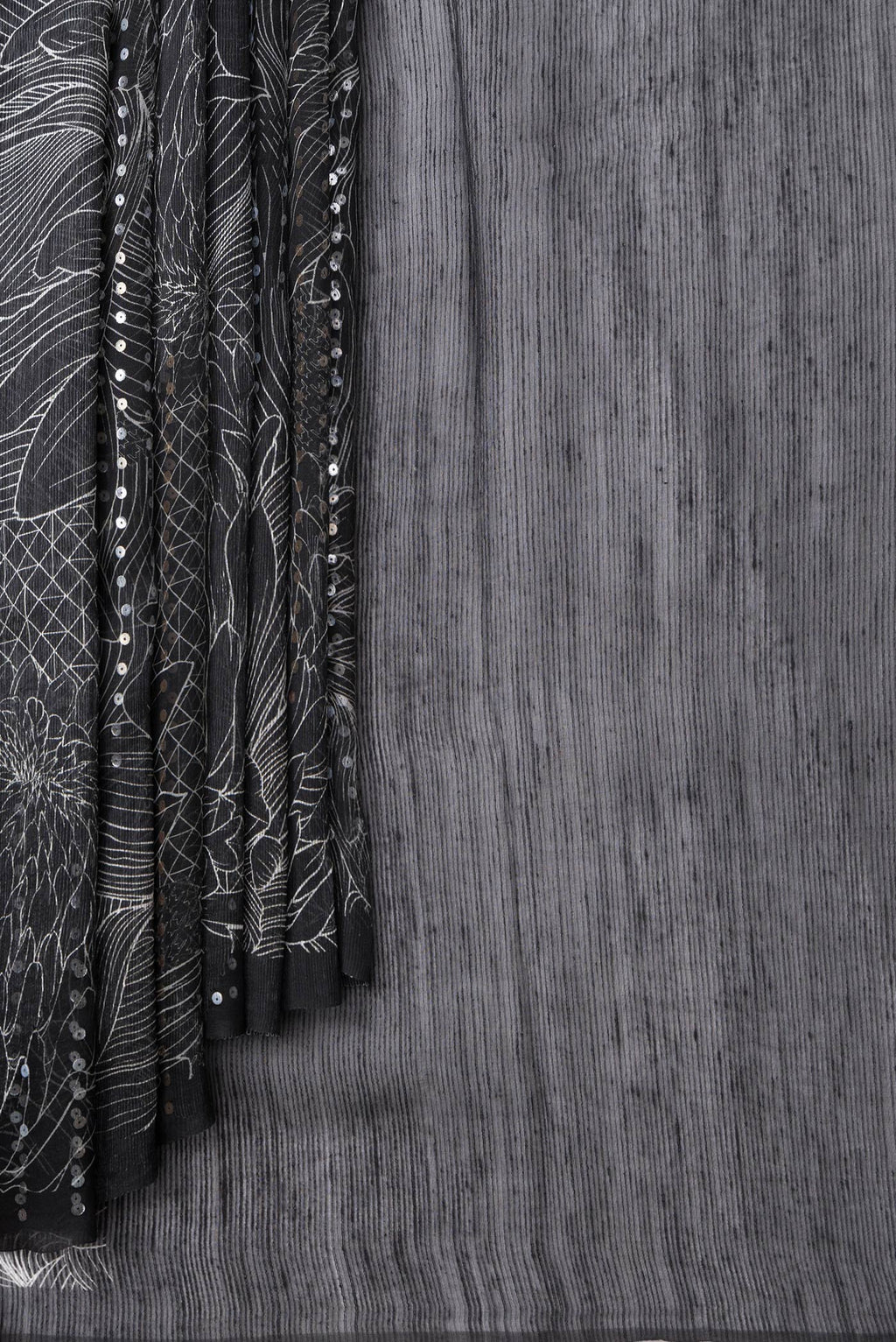 Pleats and pallu of Black Dual Tone Tussar Silk Saree with Printed design on the body and Without Border. 