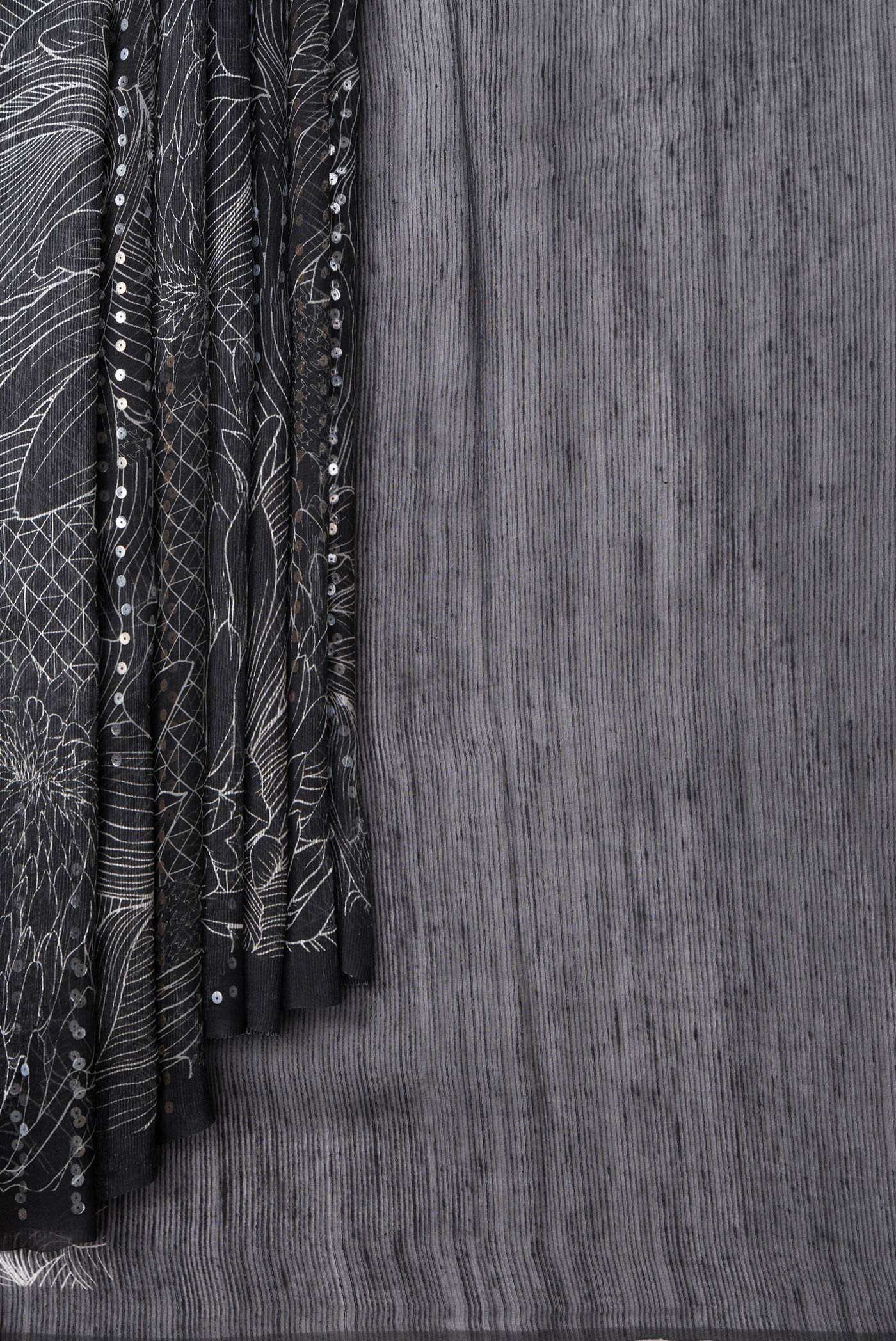 Pleats and pallu of Black Dual Tone Tussar Silk Saree with Printed design on the body and Without Border. 