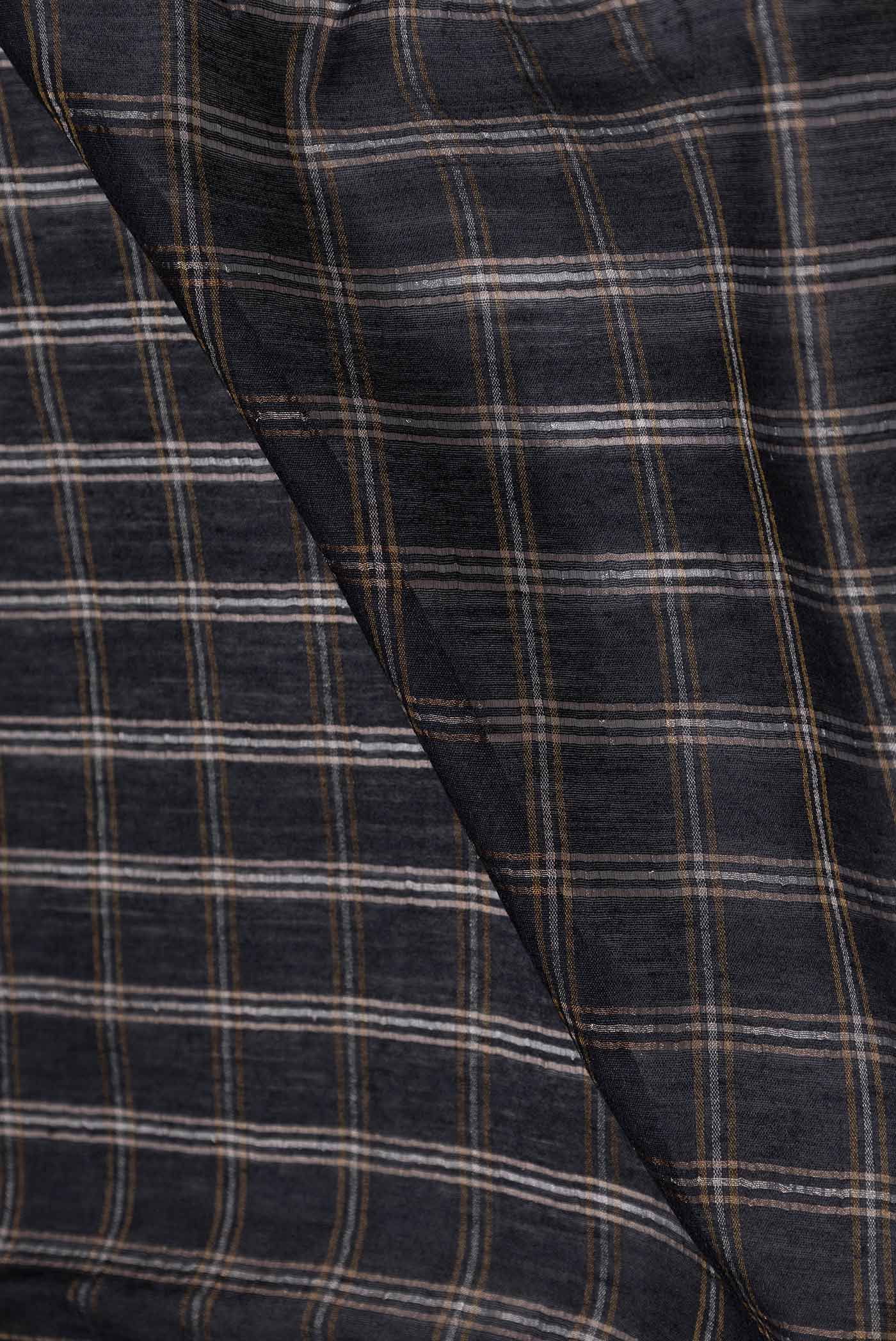 Close up of Black Tussar Silk Saree with Checked design on the body and Embroidery Border displaying folds