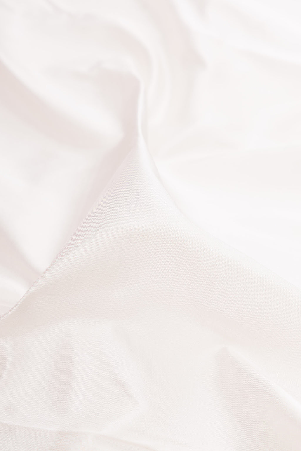 Close up of White Kanjivaram Silk Nine Yards Saree with Plain Body and Zari Border.  displaying folds