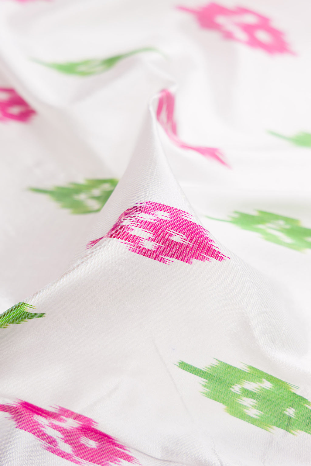 Close up of White Double Ikat Saree with Ikat Print on the body and Ikat Border.  displaying folds