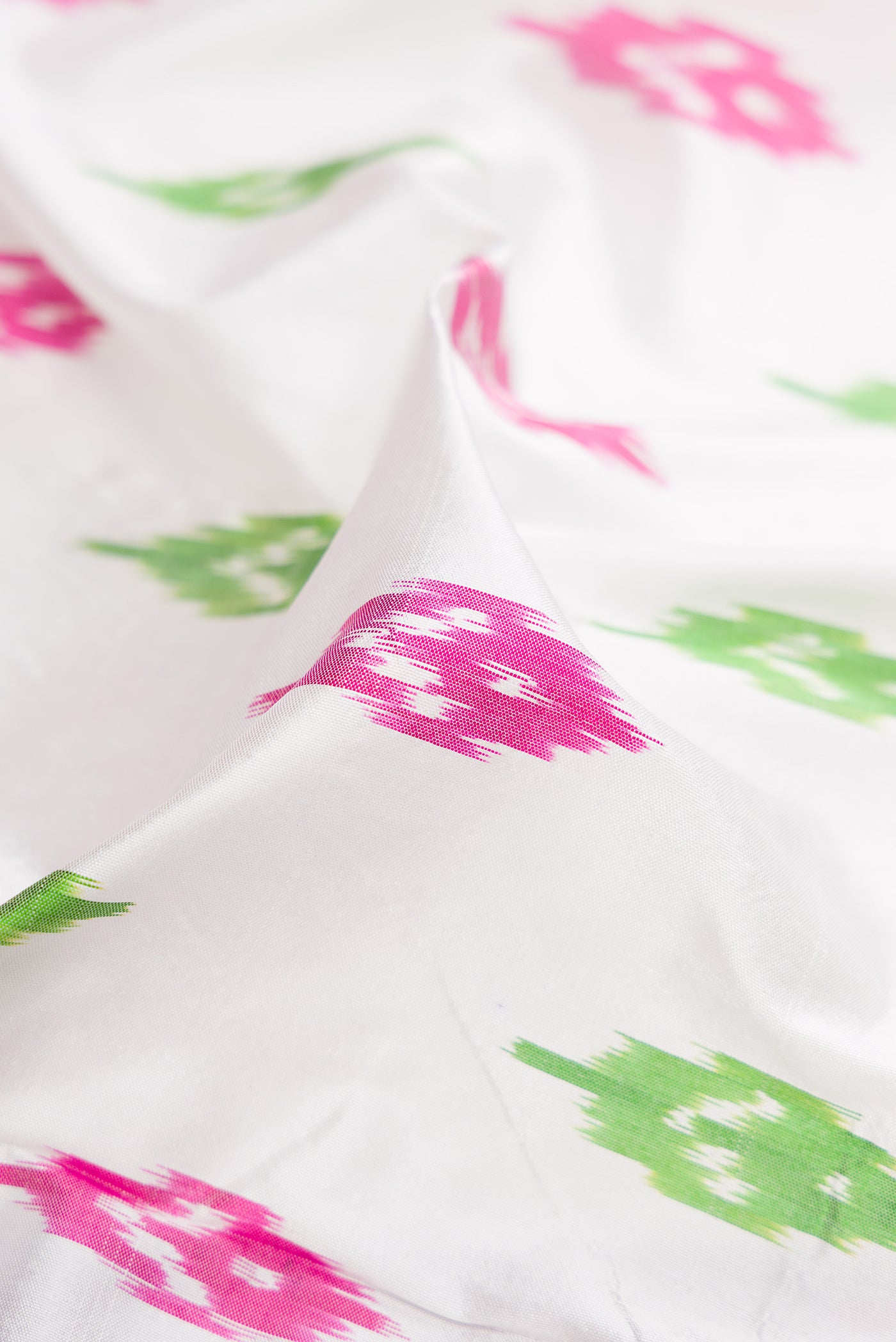 Close up of White Double Ikat Saree with Ikat Print on the body and Ikat Border.  displaying folds