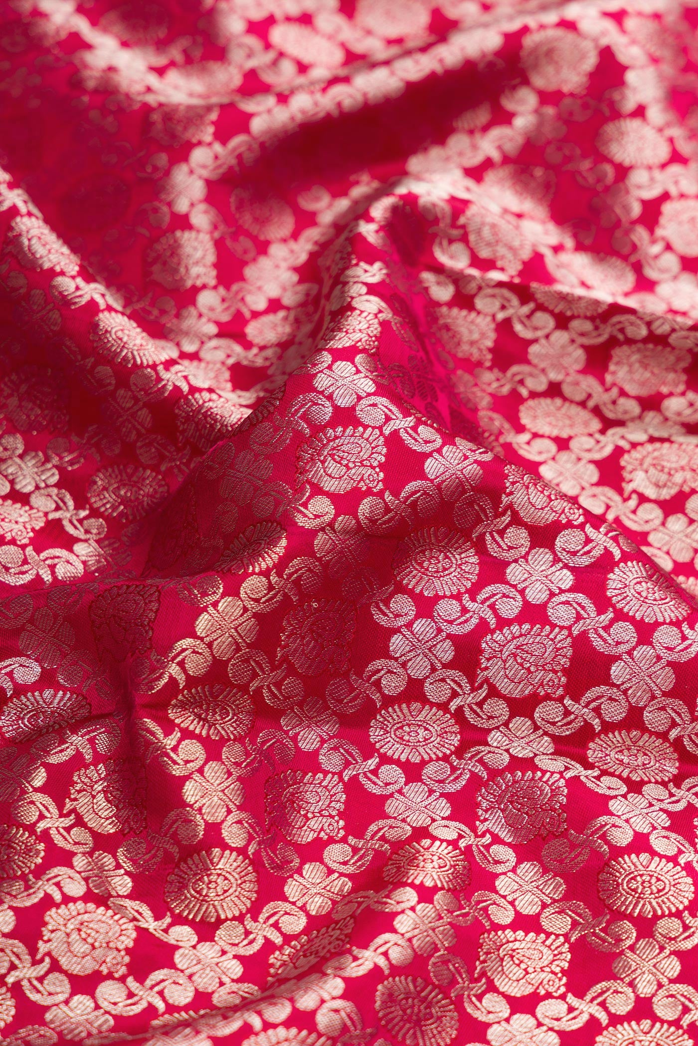 Close up of Pink Dual Tone Kanjivaram Silk Saree with Zari Brocade on the body and Zari Border.  displaying folds