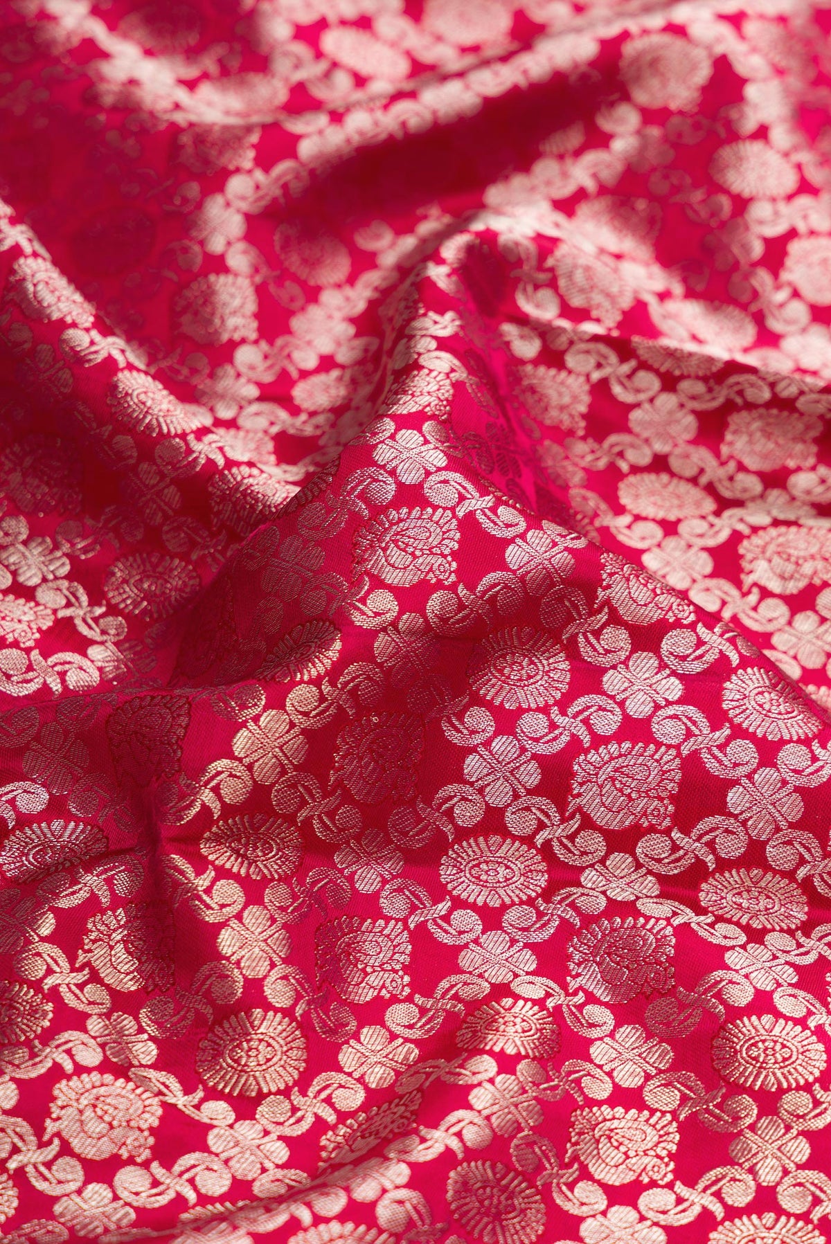 Close up of Pink Dual Tone Kanjivaram Silk Saree with Zari Brocade on the body and Zari Border.  displaying folds