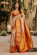 Model wearing a Gold with Red Color Kanchipuram Tissue Silk Saree with Zari Brocade on the body and Zari Border.