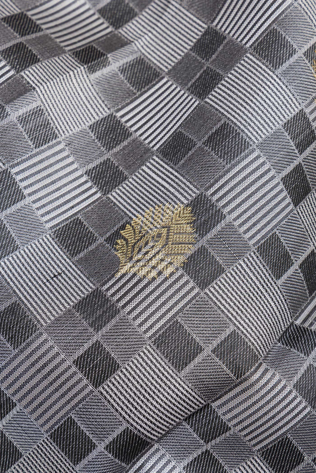 Close up of Pure Silk Grey Kanchipuram Saree with Jacquard With Zari Butta on the body and Zari Border.  displaying folds