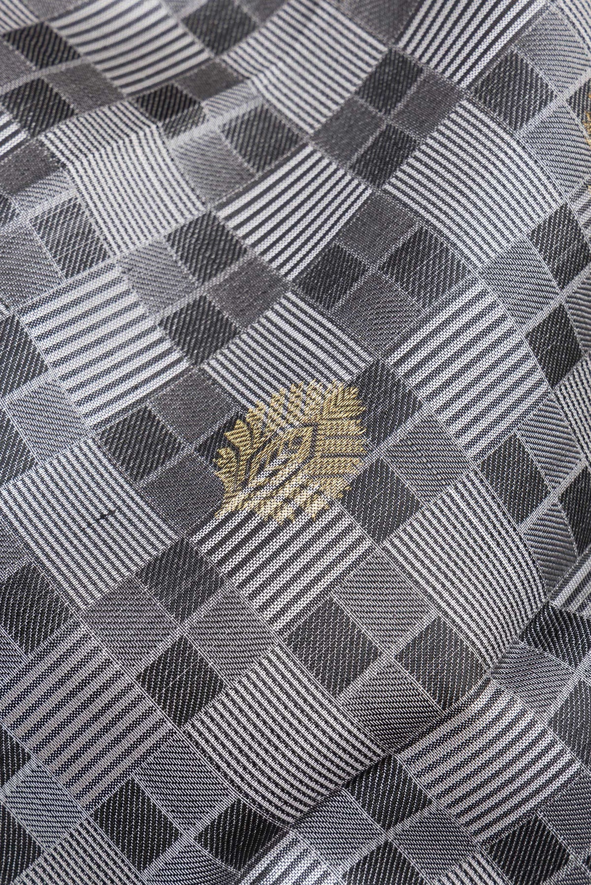 Close up of Pure Silk Grey Kanchipuram Saree with Jacquard With Zari Butta on the body and Zari Border.  displaying folds