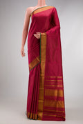 Maroon Kanchipuram Silk Saree with Stripes on the body and Zari Border.  displayed on a mannequin