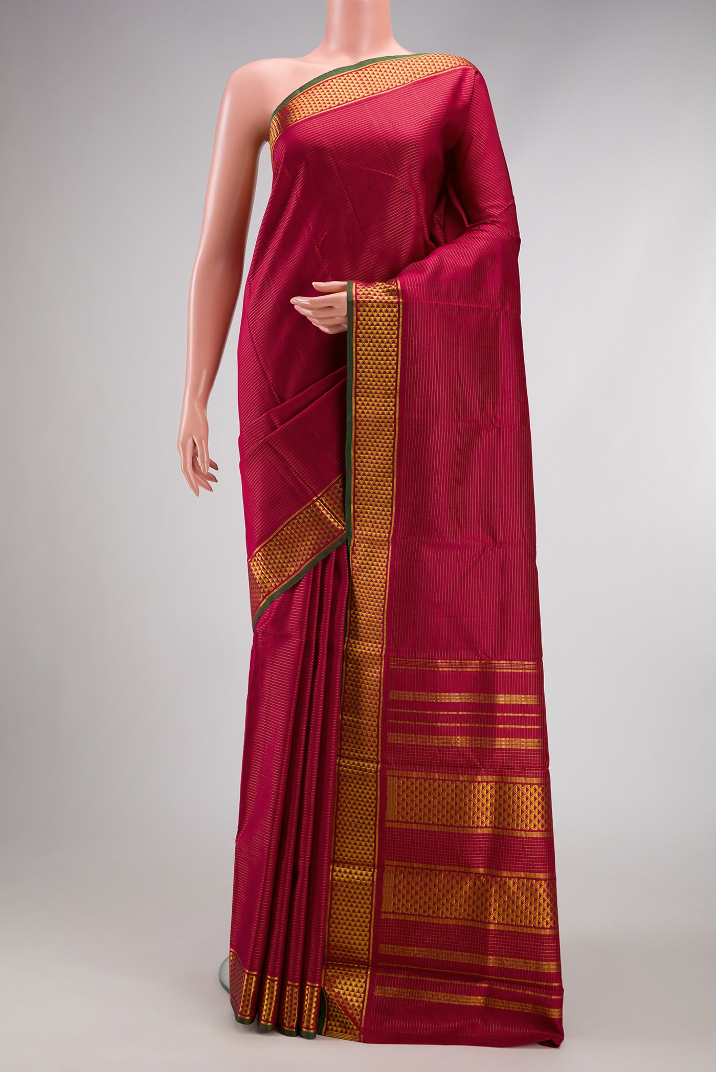 Maroon Kanchipuram Silk Saree with Stripes on the body and Zari Border.  displayed on a mannequin