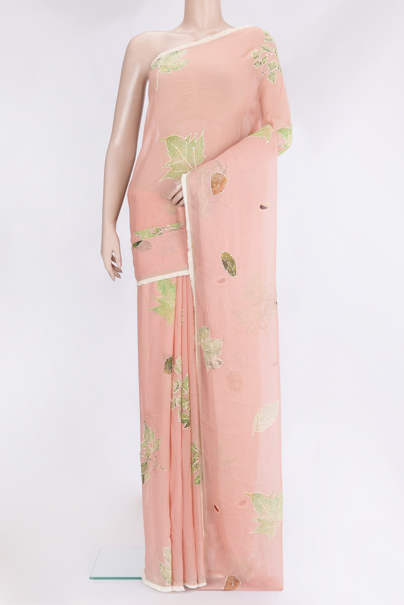 Peach Georgette Saree with Embroidery on the body and Embroidery Border.  displayed on a mannequin