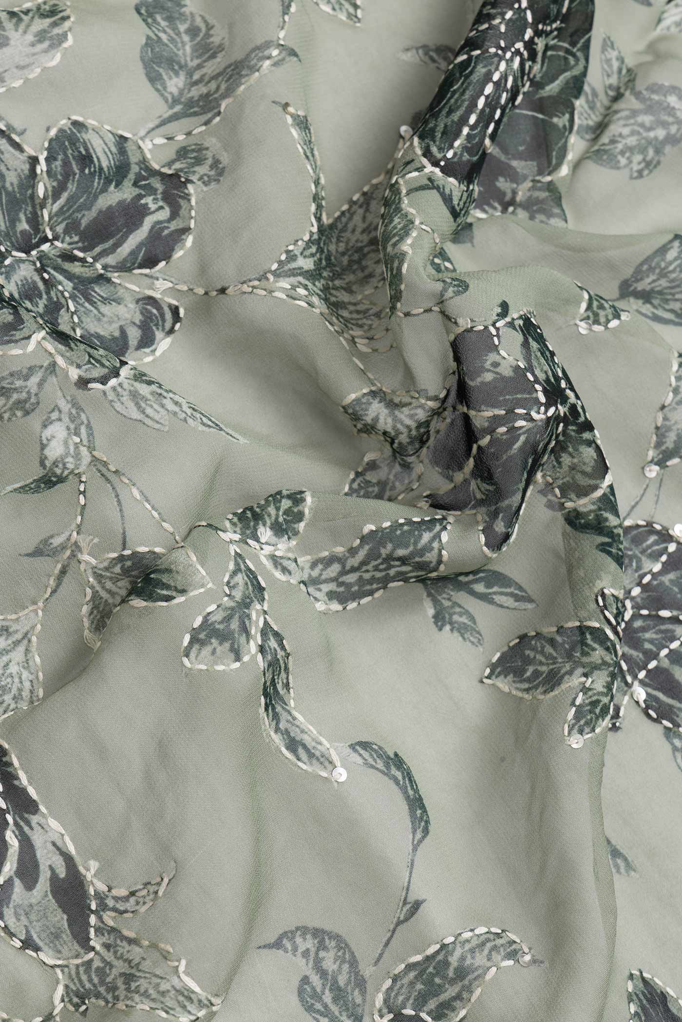 Close up of Light Green Dual Tone Mysore Georgette Saree with Embroidery on the body and Embroidery Border.  displaying folds