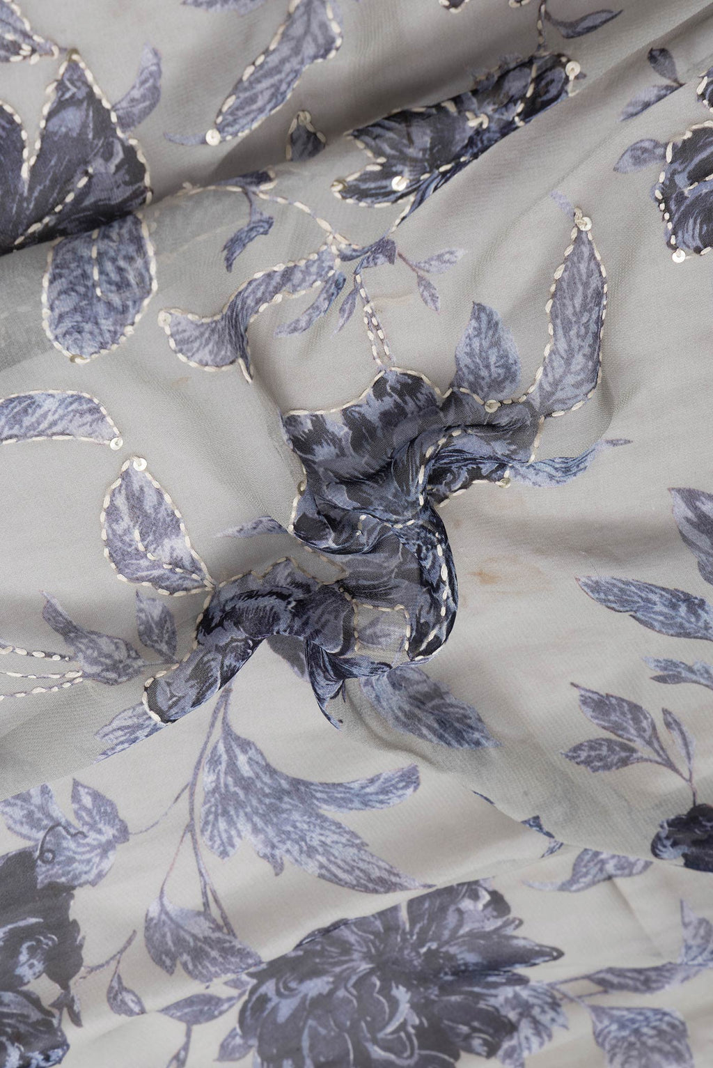 Close up of Grey Dual Tone Mysore Georgette Saree with Embroidery on the body and Embroidery Border.  displaying folds