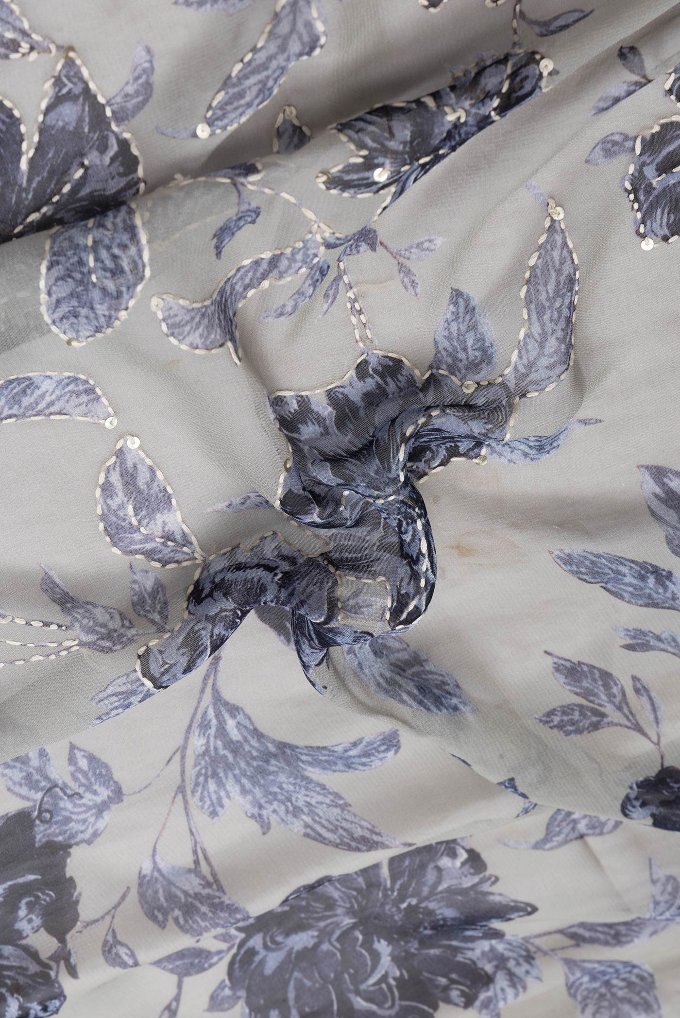 Close up of Grey Dual Tone Mysore Georgette Saree with Embroidery on the body and Embroidery Border.  displaying folds
