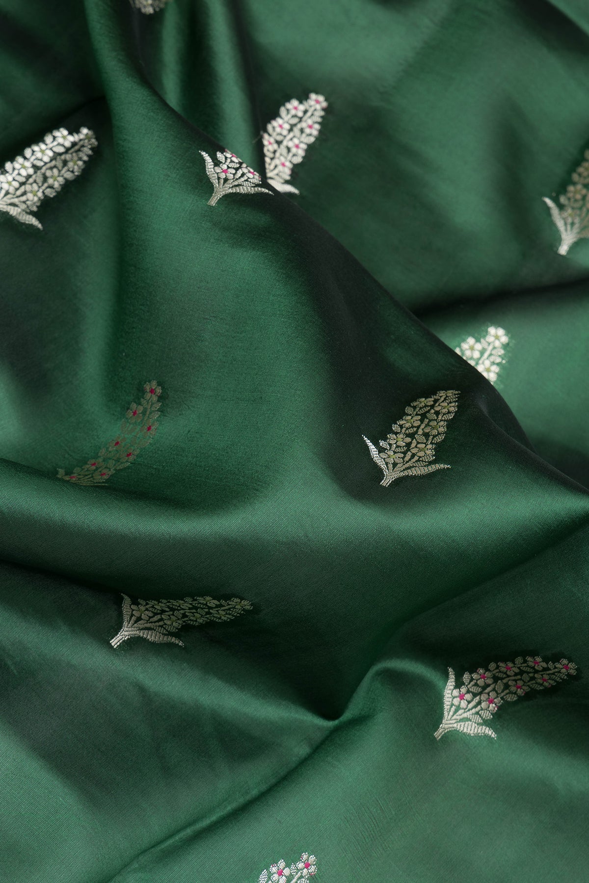 Close up of Bottle Green Dual Tone Tussar Silk Saree with Zari Butta on the body and Fancy Border.  displaying folds