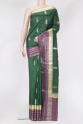 Bottle Green Dual Tone Tussar Silk Saree with Zari Butta on the body and Fancy Border.  displayed on a mannequin