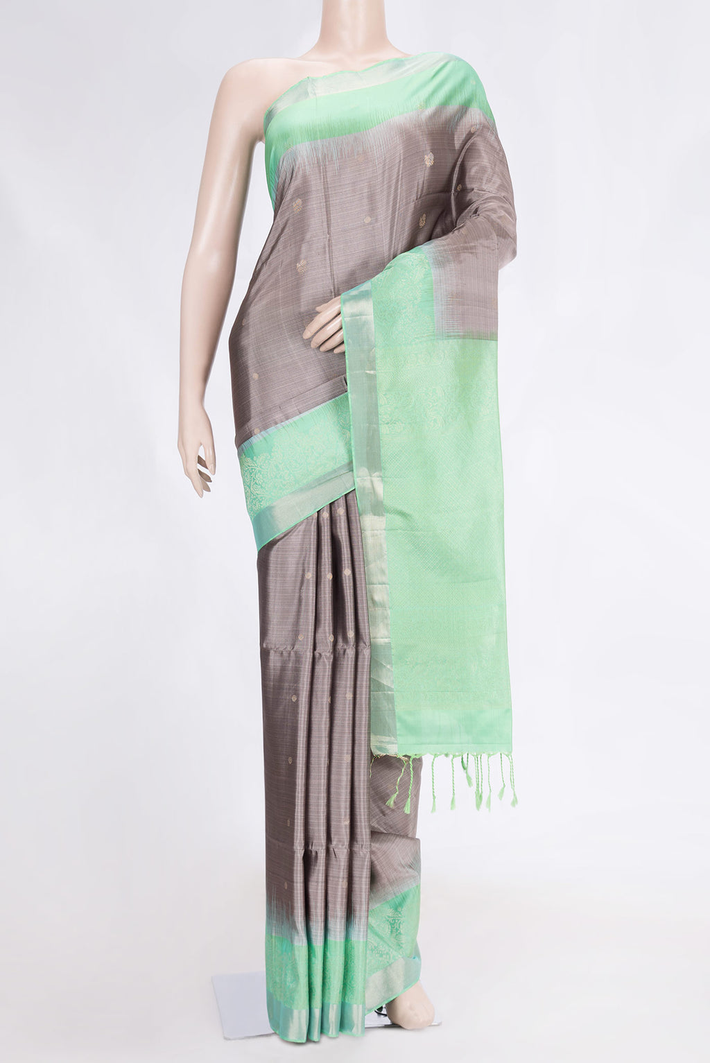 Grey Dual Tone Soft Silk Saree with Zari Butta on the body and Fancy Border.  displayed on a mannequin