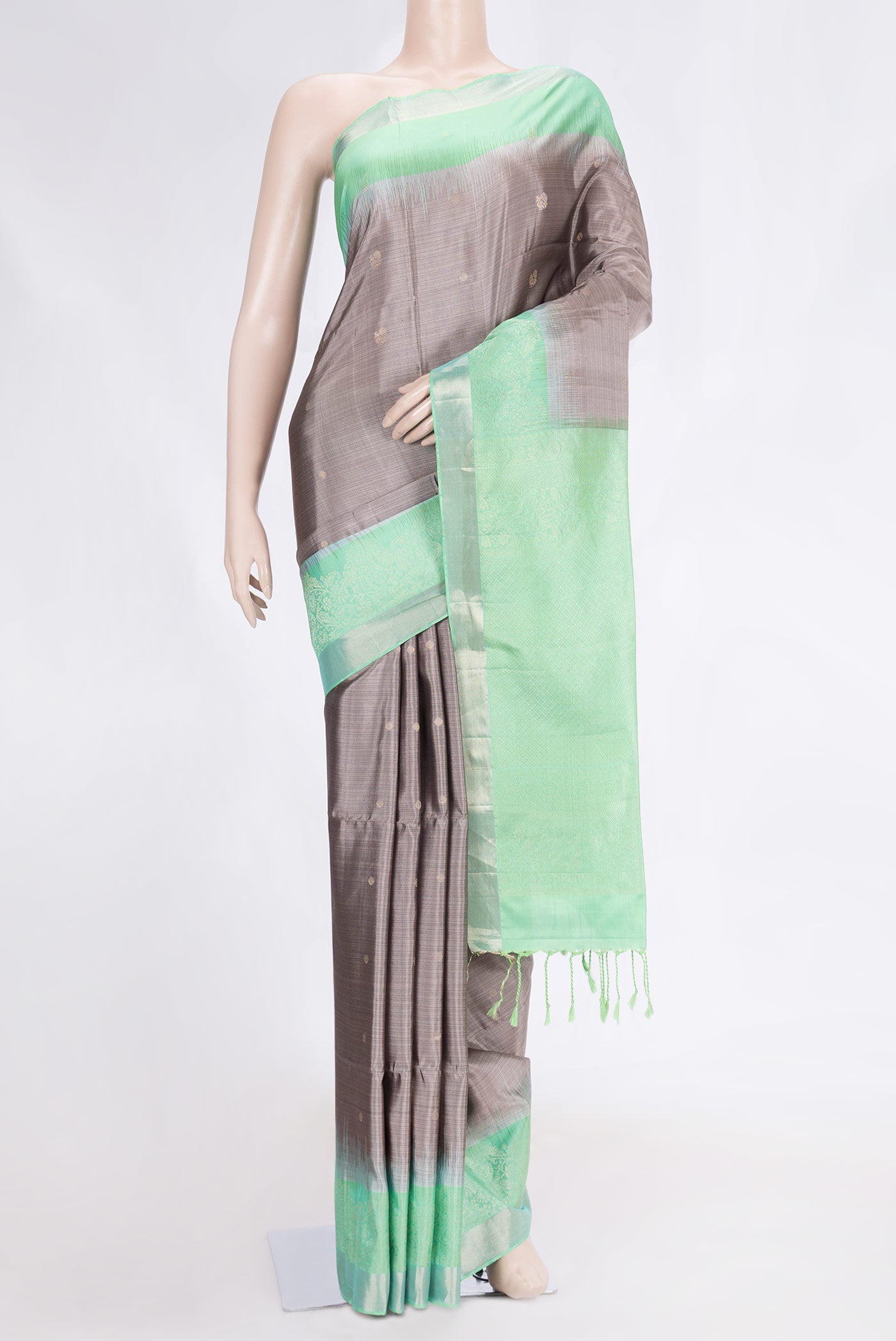 Grey Dual Tone Soft Silk Saree with Zari Butta on the body and Fancy Border.  displayed on a mannequin
