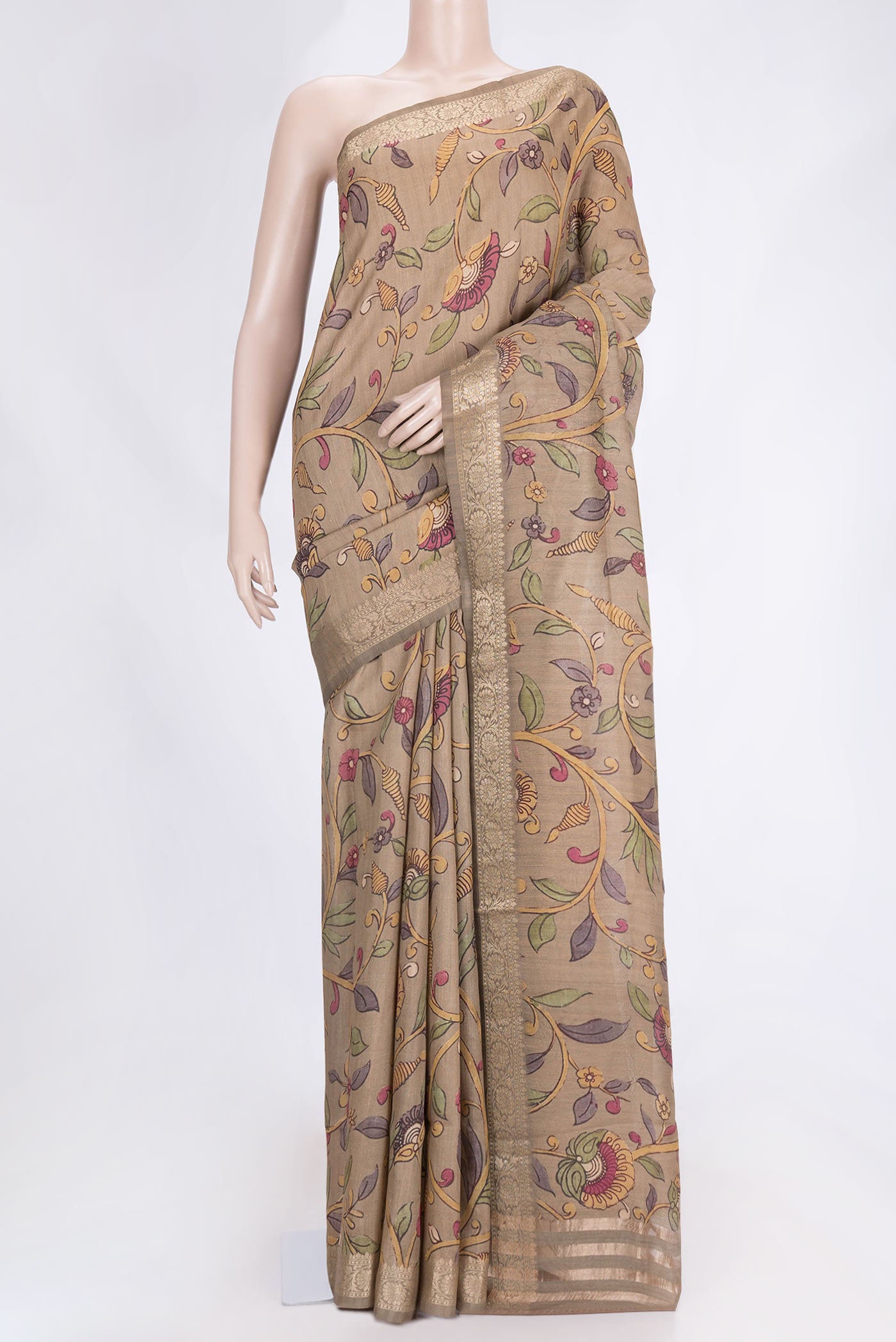 Beige Dual Tone Tussar Saree with kalamkari Print on the body and Zari Border.  displayed on a mannequin