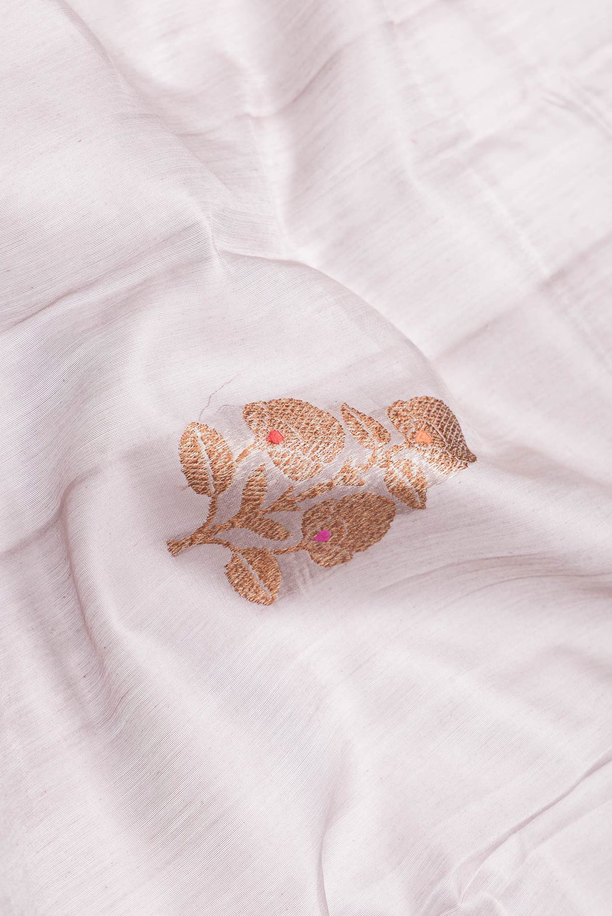 Close up of Grey Dual Tone Tussar Silk Saree with Zari Butta on the body and Zari Border.  displaying folds