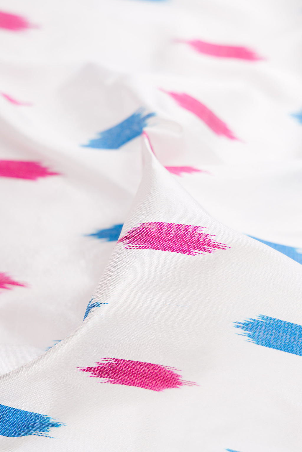 Close up of White Double Ikat Saree with Ikat Print on the body and Ikat Border.  displaying folds