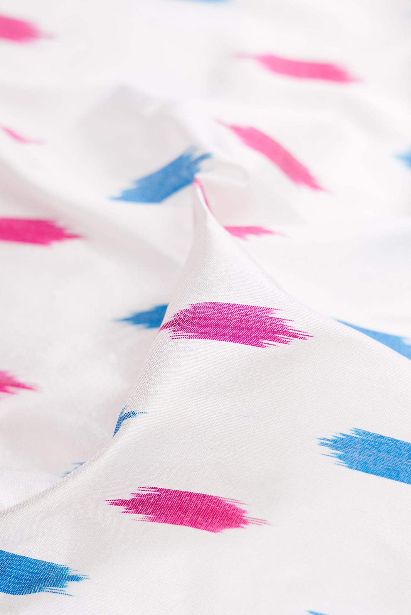 Close up of White Double Ikat Saree with Ikat Print on the body and Ikat Border.  displaying folds
