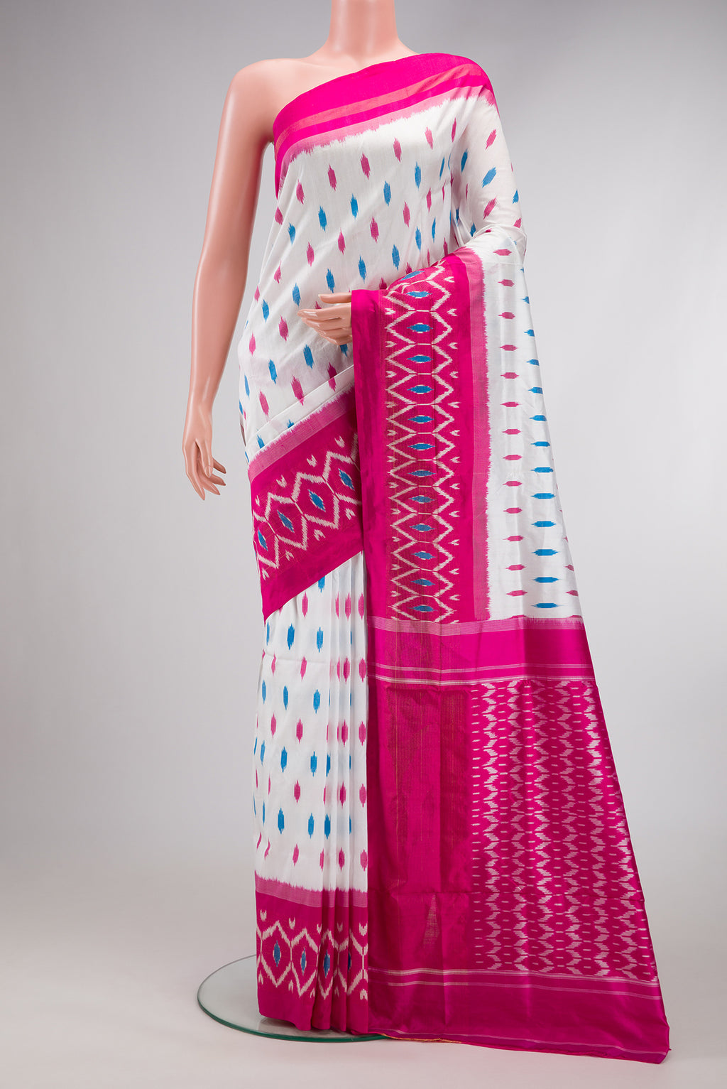 White Double Ikat Saree with Ikat Print on the body and Ikat Border.  displayed on a mannequin