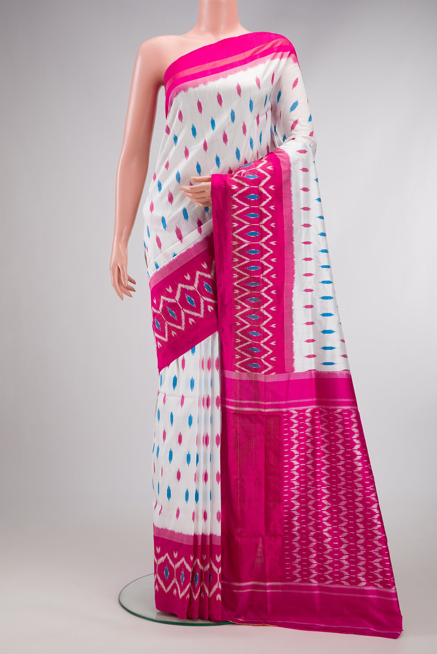 White Double Ikat Saree with Ikat Print on the body and Ikat Border.  displayed on a mannequin