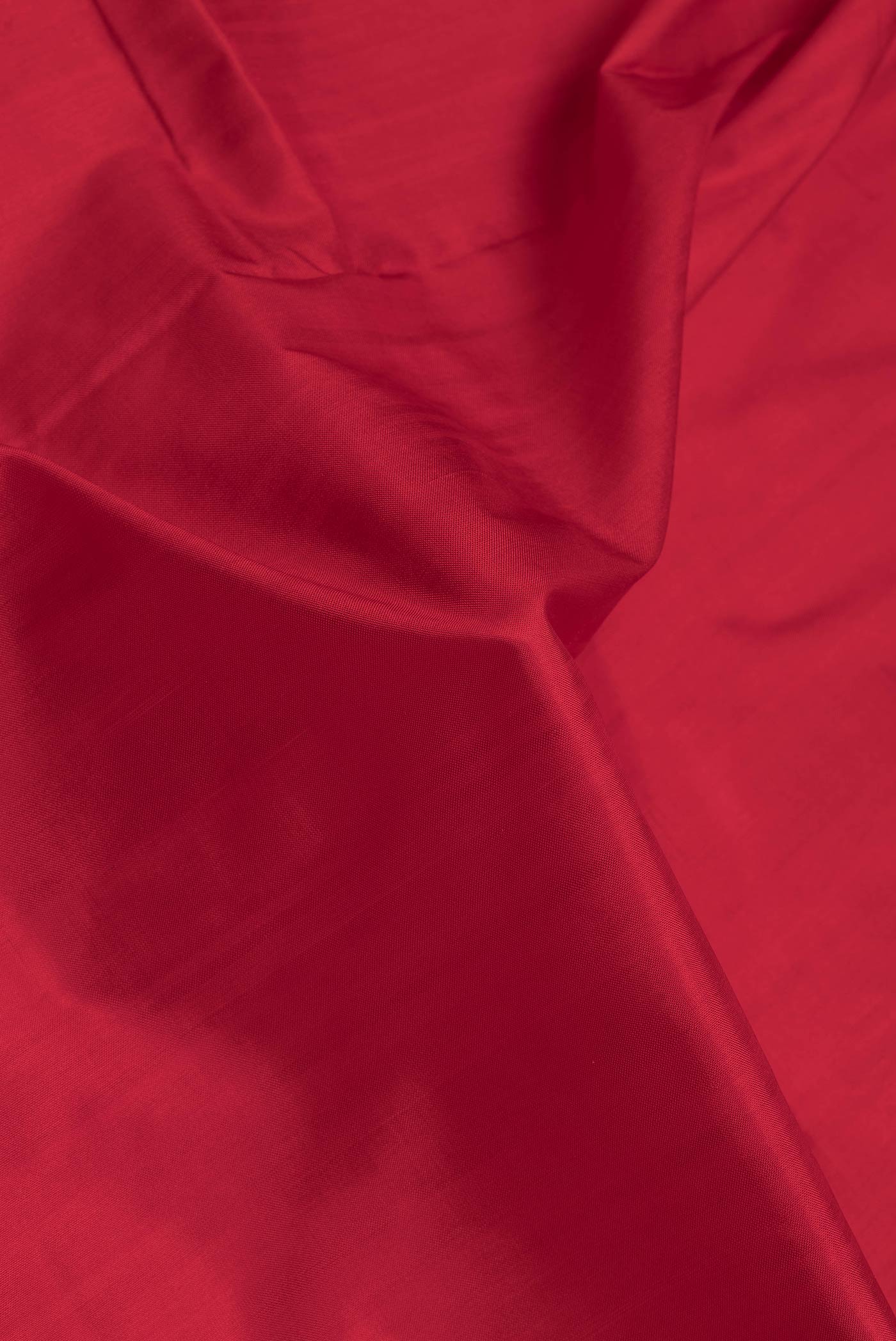 Close up of Red Dual Tone Double Ikat Saree with Ikat Print on the body and Ikat Border.  displaying folds