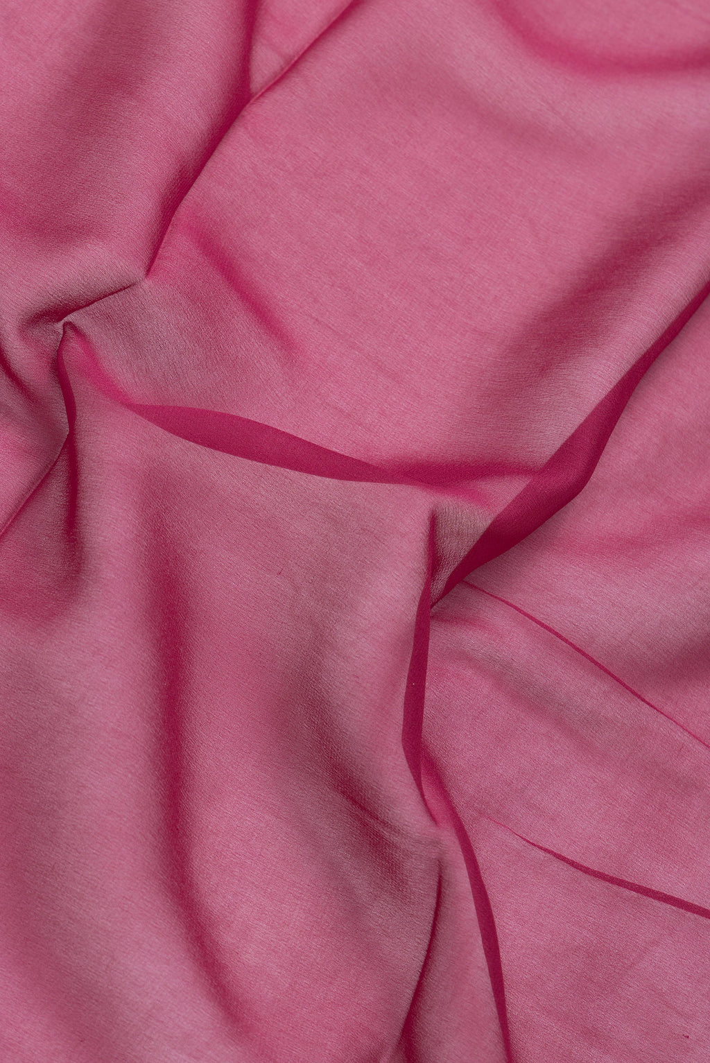 Close up of Magenta Dual Tone Mysore Georgette Saree with Plain Body and Temple Border.  displaying folds