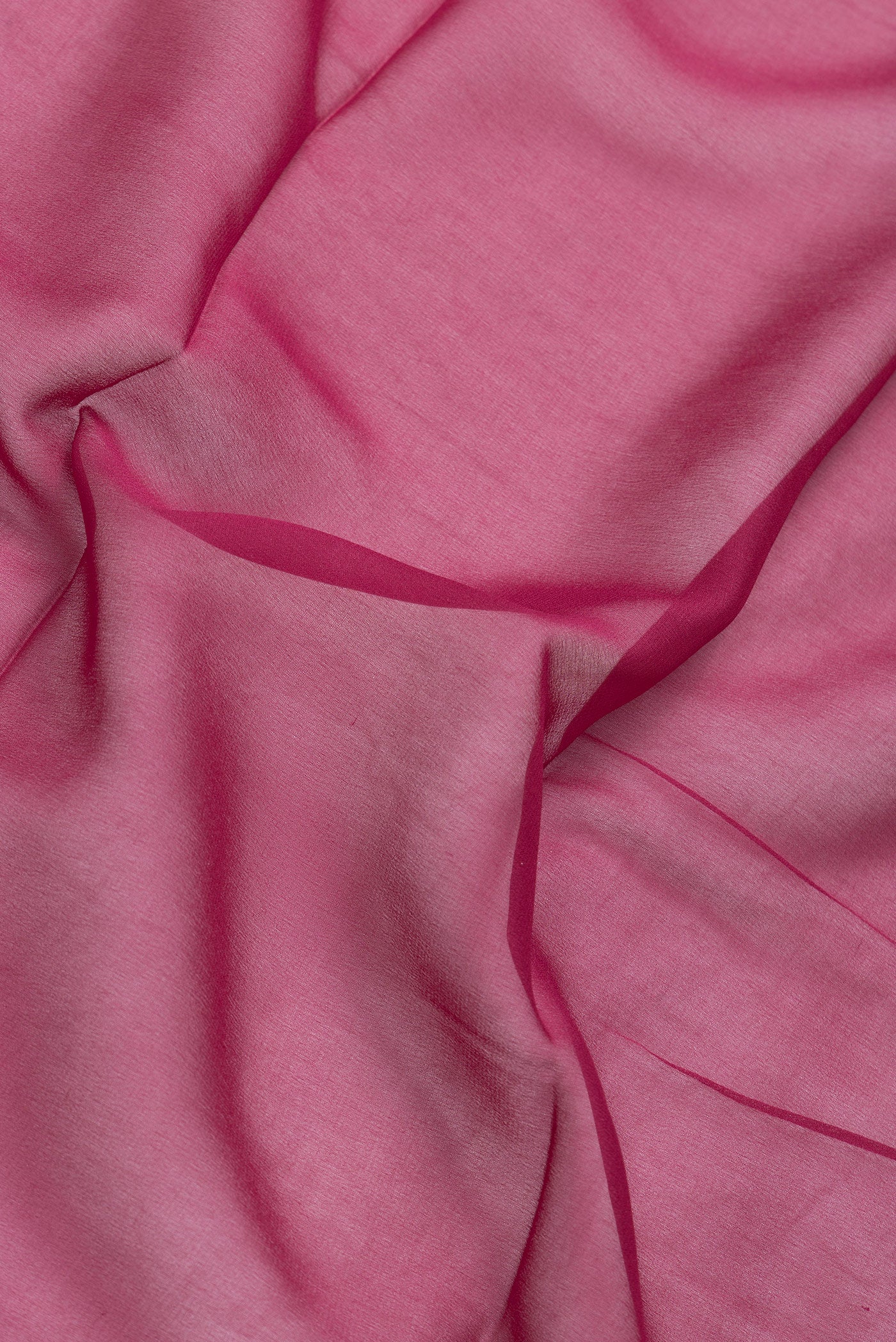 Close up of Magenta Dual Tone Mysore Georgette Saree with Plain Body and Temple Border.  displaying folds