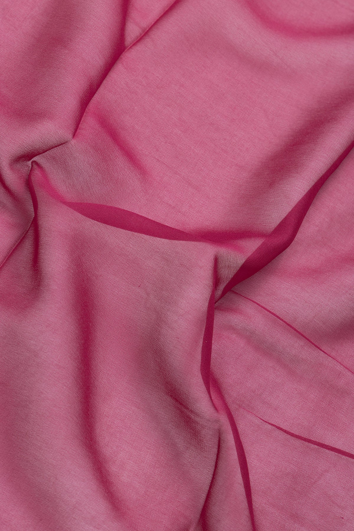 Close up of Magenta Dual Tone Mysore Georgette Saree with Plain Body and Temple Border.  displaying folds