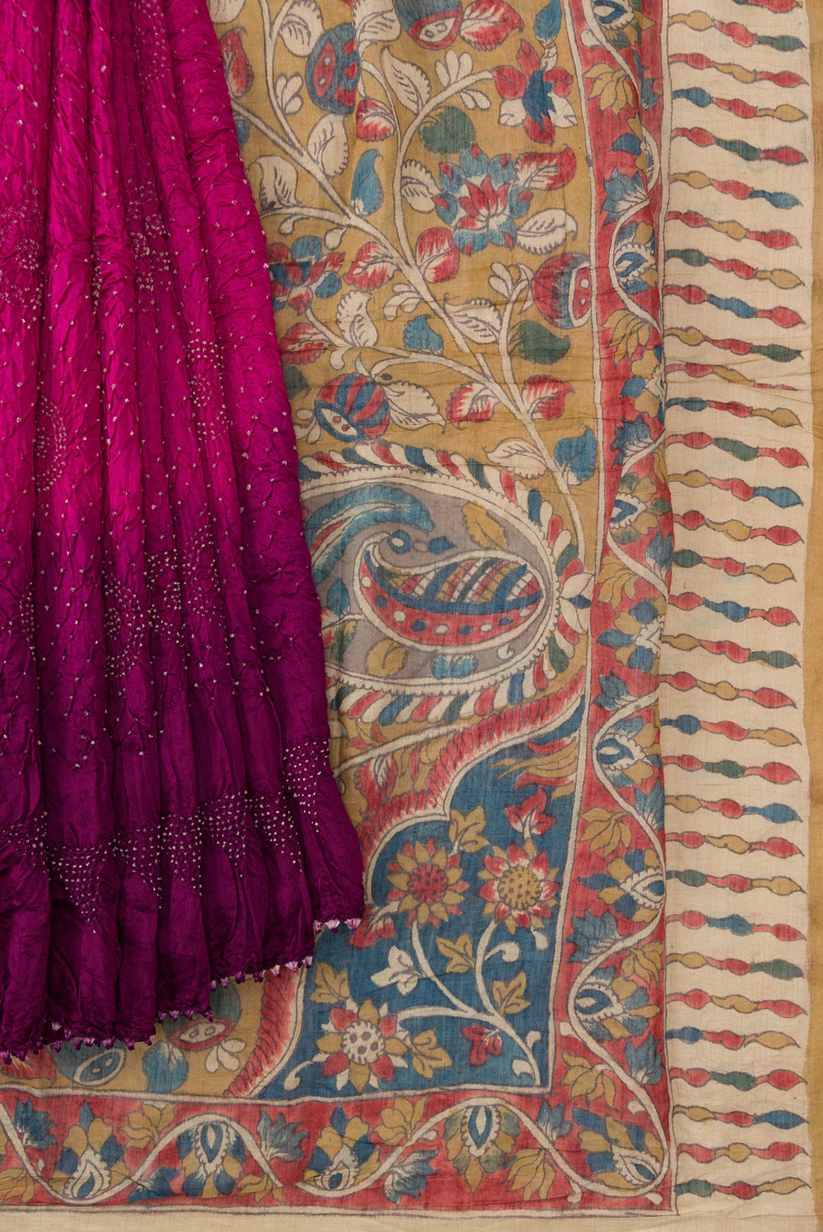 Pleats and pallu of Magenta and Purple Color Bandhani Silk Saree with Bandhani Print on the body and Printed Border. 