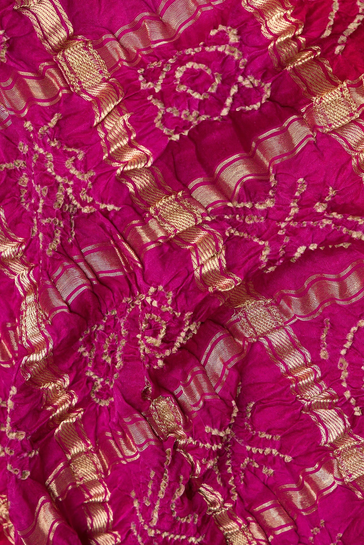 Close up of Pure Silk Pink and Red Color Bandhani Saree with Bandhani on the body and Without Border.  displaying folds