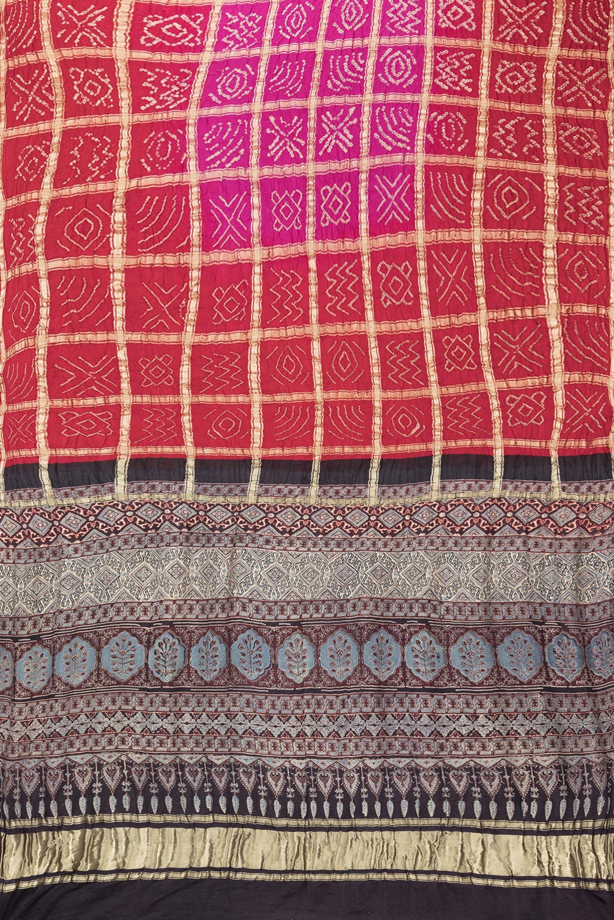 Flat view of Pure Silk Pink and Red Color Bandhani Saree with Bandhani on the body and Without Border. 