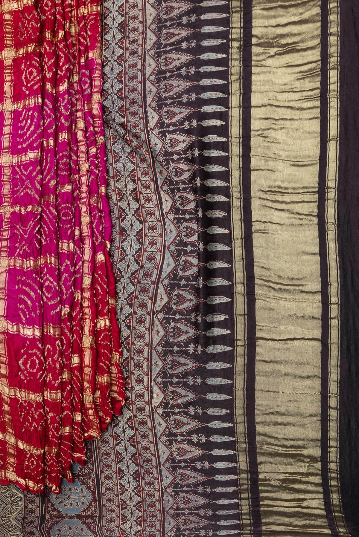 Pleats and pallu of Pure Silk Pink and Red Color Bandhani Saree with Bandhani on the body and Without Border. 