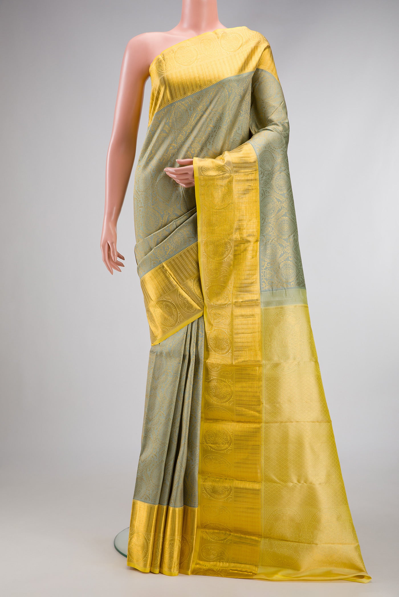Pista Green Dual Tone Kanjivaram Silk Saree with Zari Brocade on the body and Zari Border.  displayed on a mannequin