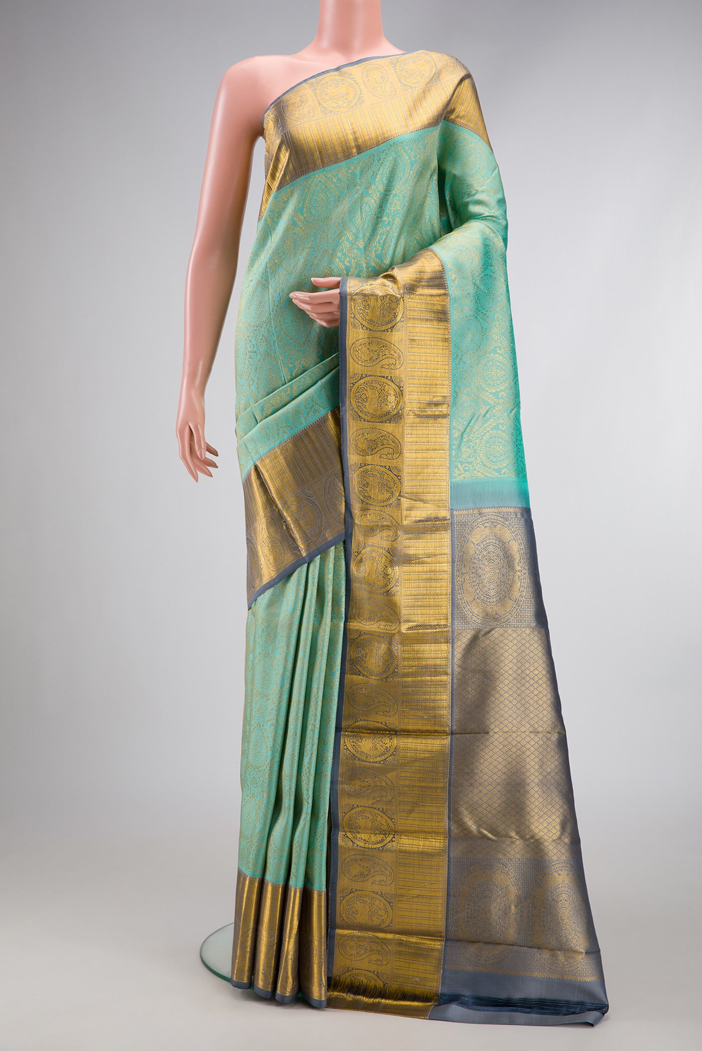 Sea Green Dual Tone Kanjivaram Silk Saree with Zari Brocade on the body and Zari Border.  displayed on a mannequin